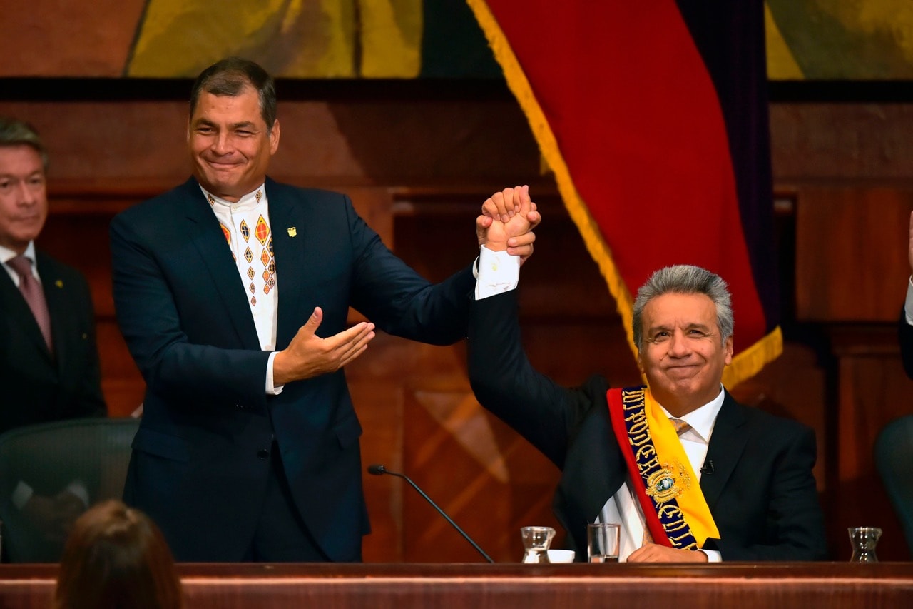 Outgoing President Rafael Correa (L) raises new President Lenin Moreno's hand at the National Assembly in Quito, Ecuador, 24 May 2017, during Moreno's inauguration ceremony, RODRIGO BUENDIA/AFP/Getty Images