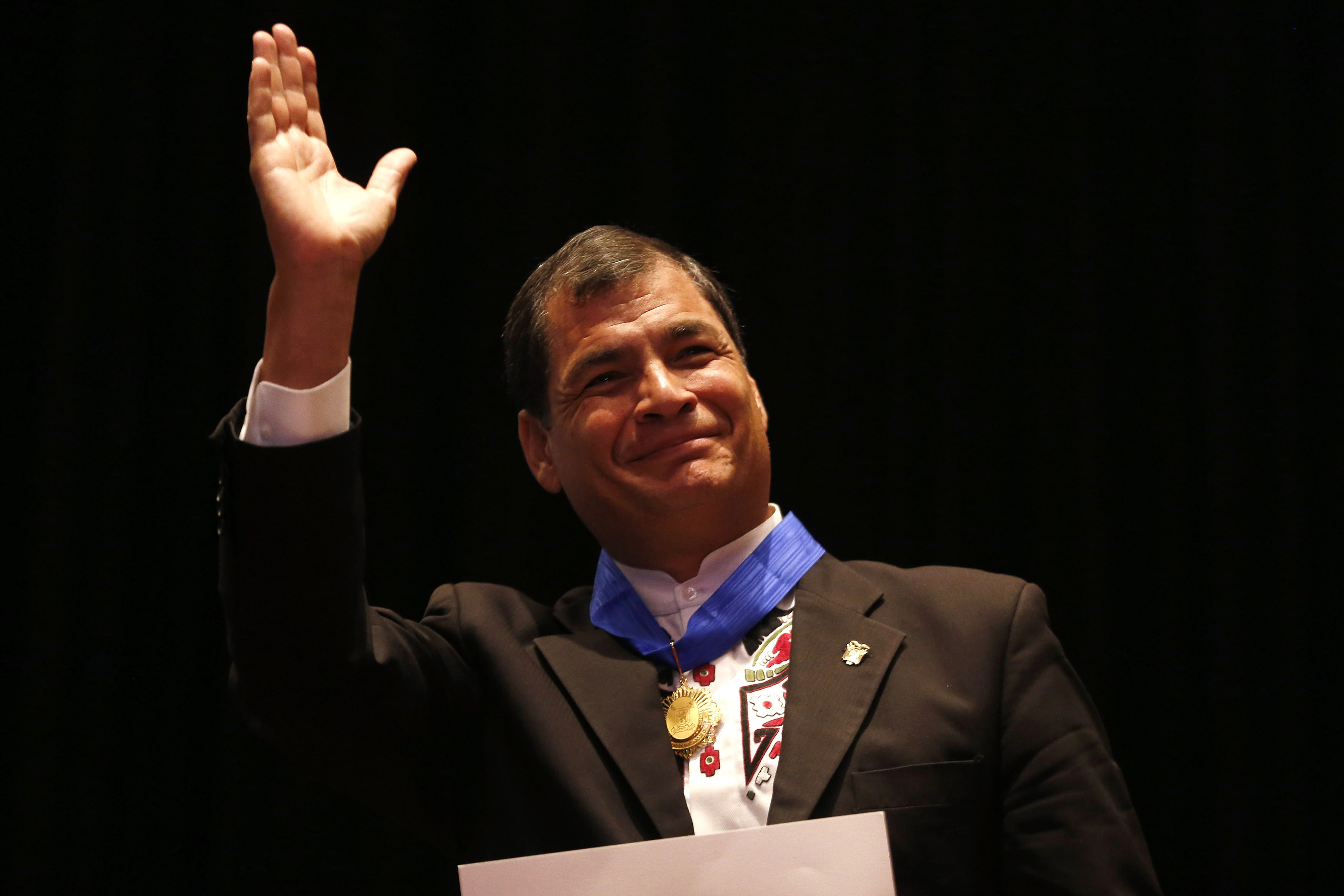 Ecuador's President Rafael Correa waves to the crowd at Santiago University during a recent trip to Chile, REUTERS/Ivan Alvarado