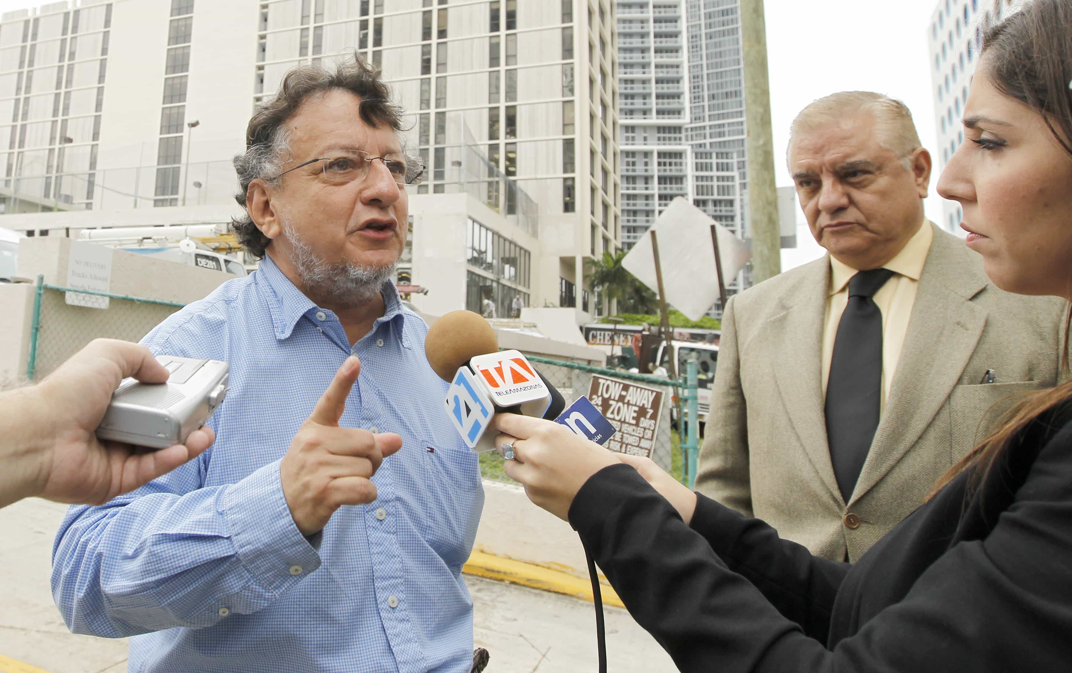 Columnist Emilio Palacio (L) speaks with the media after a meeting with officials at the U.S. Immigration Services Asylum Office in Miami, Florida February 8, 2012, REUTERS/Joe Skipper