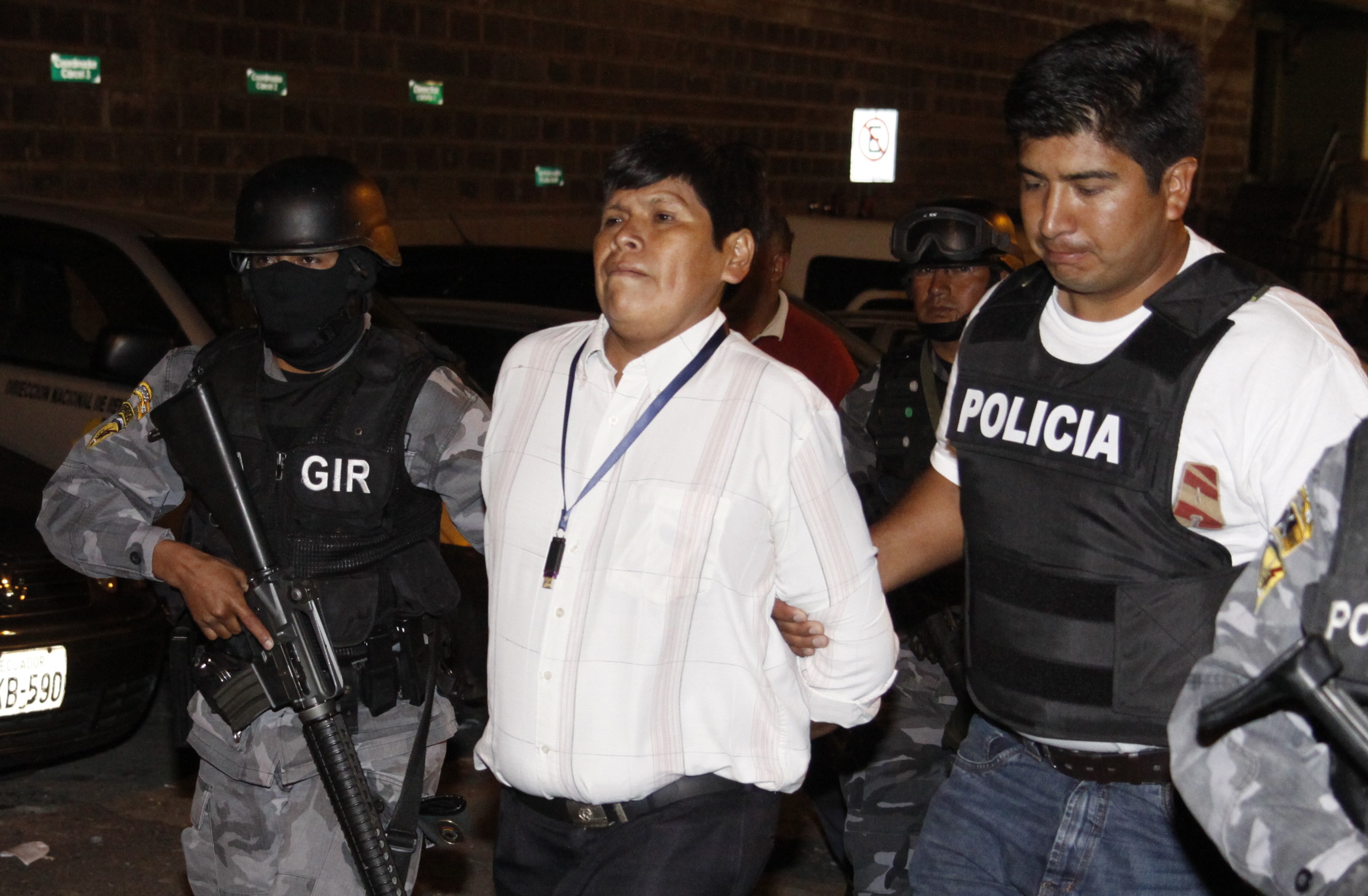 Indigenous leader Pepe Acacho escorted by police in 2011, when he was first arrested for the crimes of sabotage and terrorism, AP