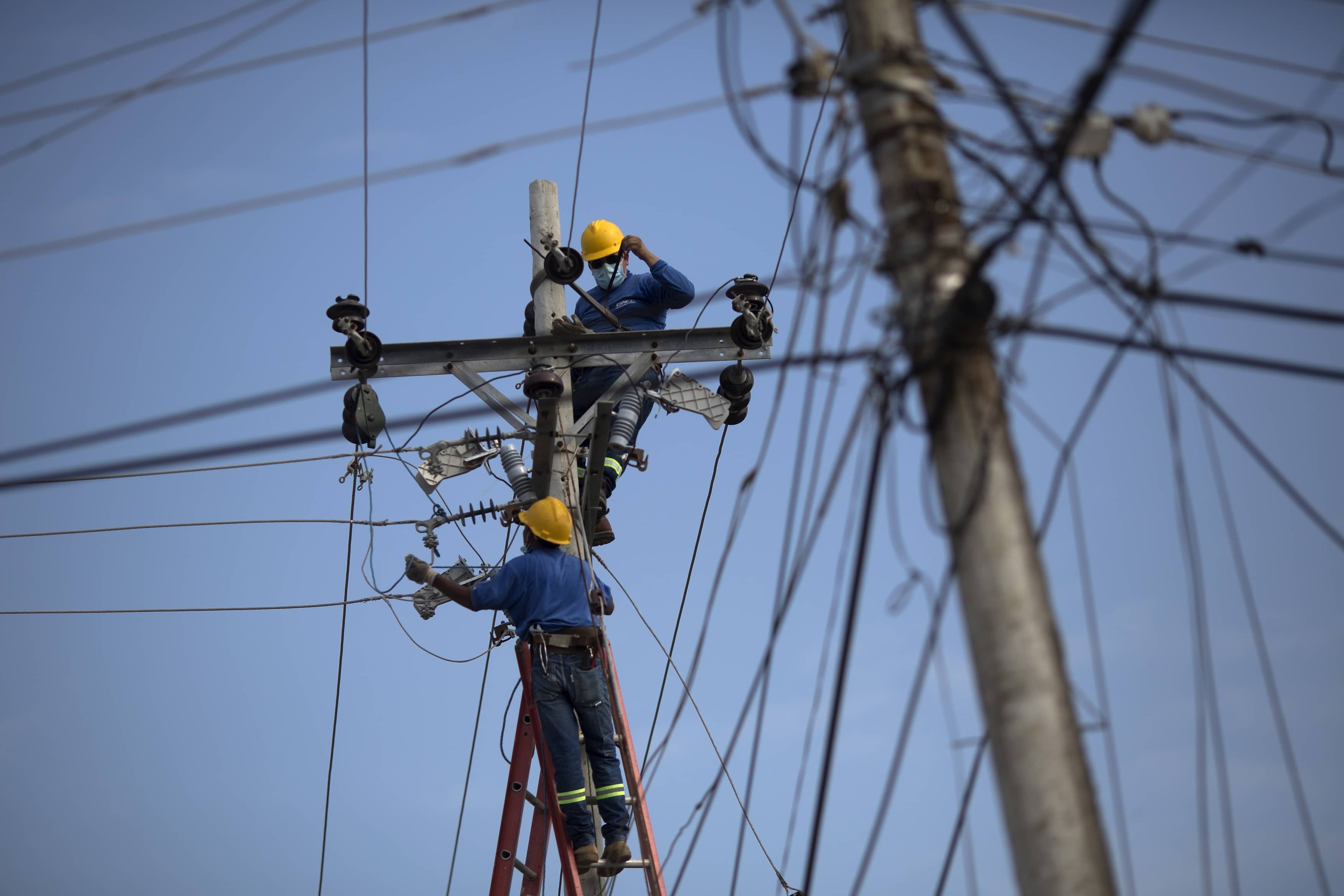 Workers repair electricity lines damaged in the earthquake in Canoa, Ecuador, AP Photo/Rodrigo Abd