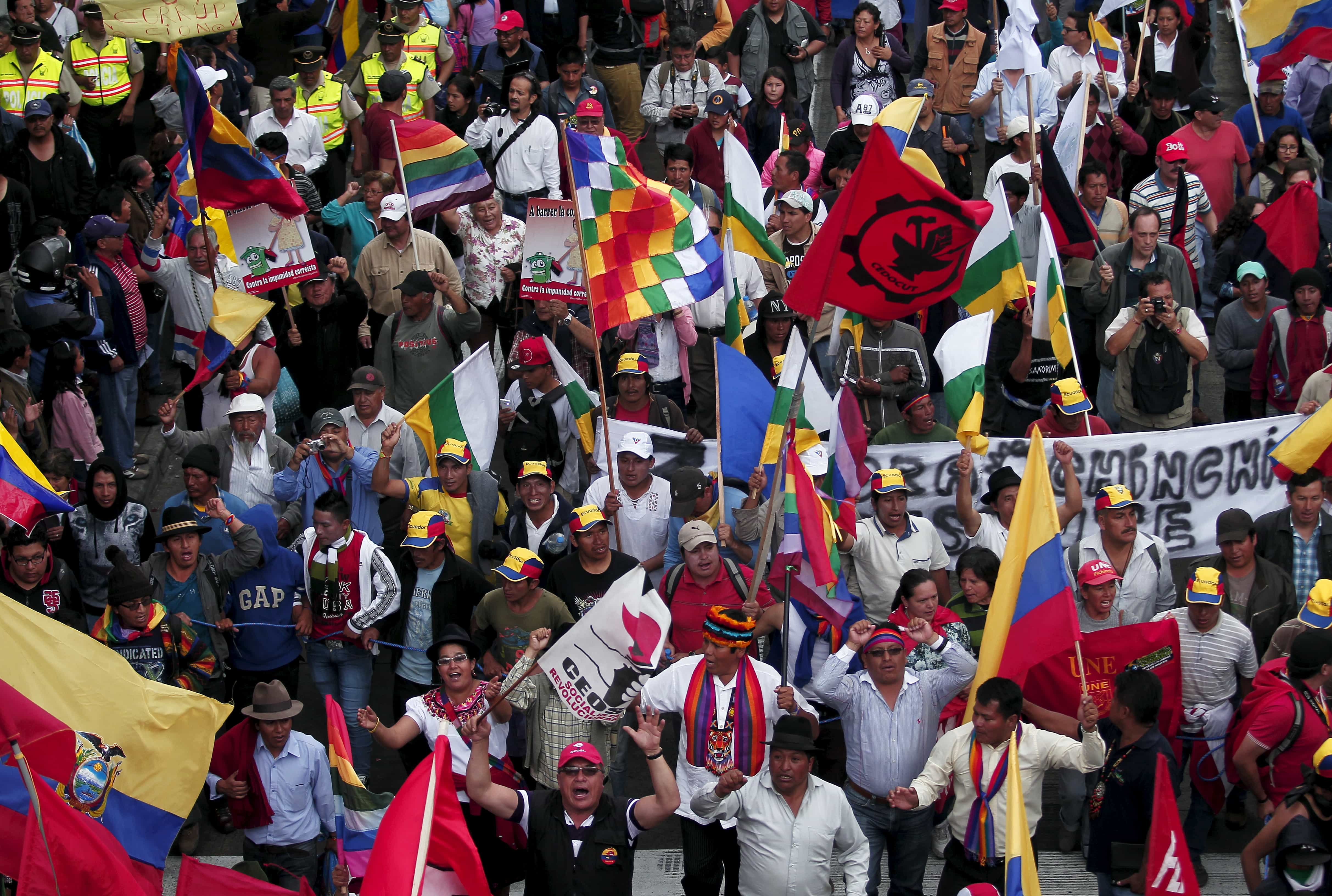Protesters carry flags and banners while marching in Quito, Ecuador, August 12, 2015, REUTERS/Guillermo Granja
