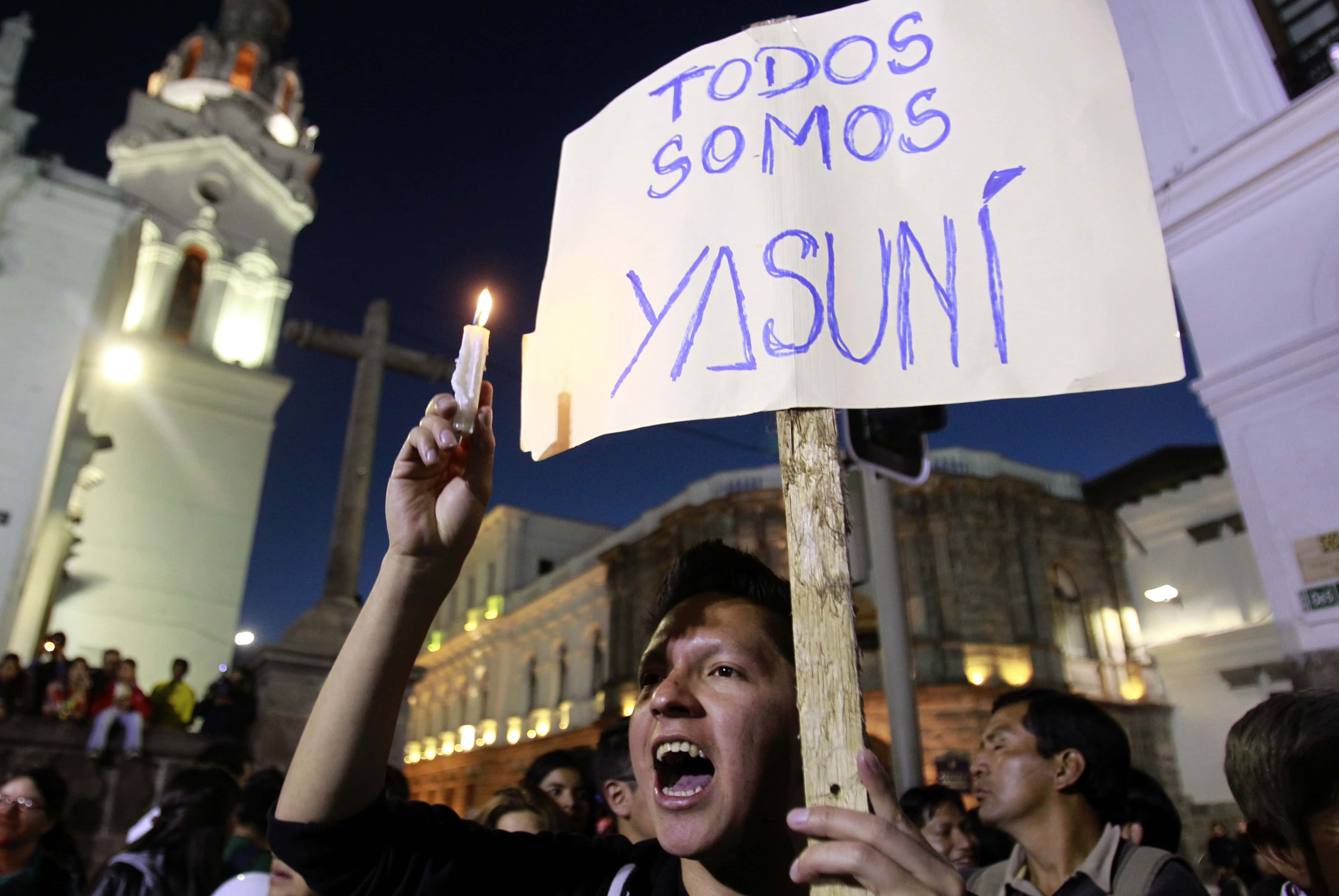 A young man holding a sign that reads in Spanish "We are all Yasuní," joins others in protest against oil drilling in the Amazon reserve, Yasuní National Park, AP Photo/Dolores Ochoa