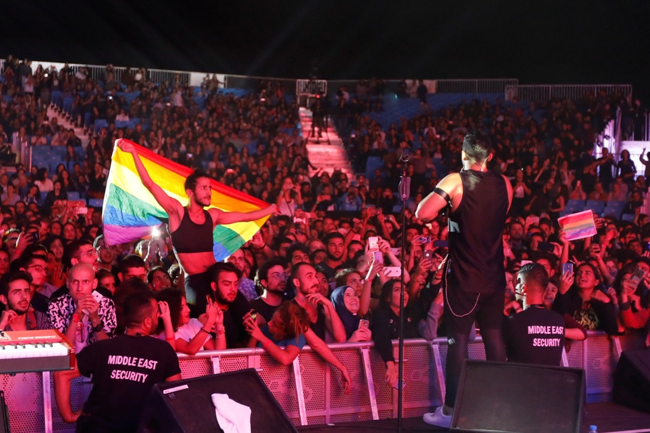 A fan of Lebanese band Mashrou' Leila holds a rainbow flag during their concert in Ehden town, Lebanon, 12 August 2017 , REUTERS/Jamal Saidi