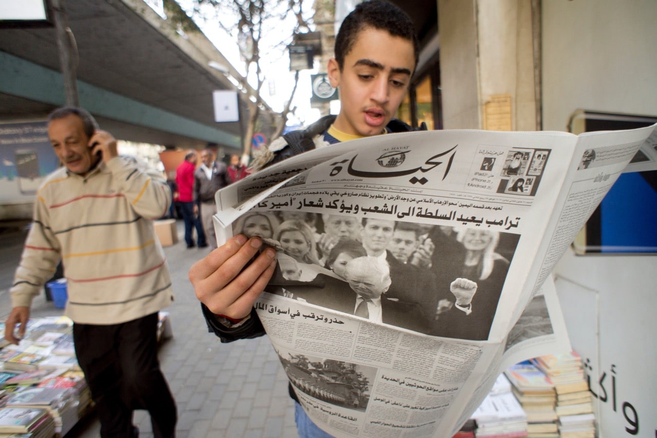 A young man reads a copy of "Alhayat" newspaper in Cairo, Egypt, 21 January 2017, AP Photo/Amr Nabil