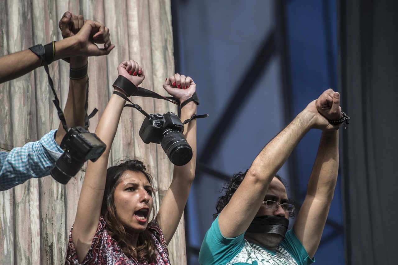 Egyptian photojournalists raise their cameras during a demonstration outside the Syndicate headquarters in Cairo, 3 May 2016, KHALED DESOUKI/AFP/Getty Images