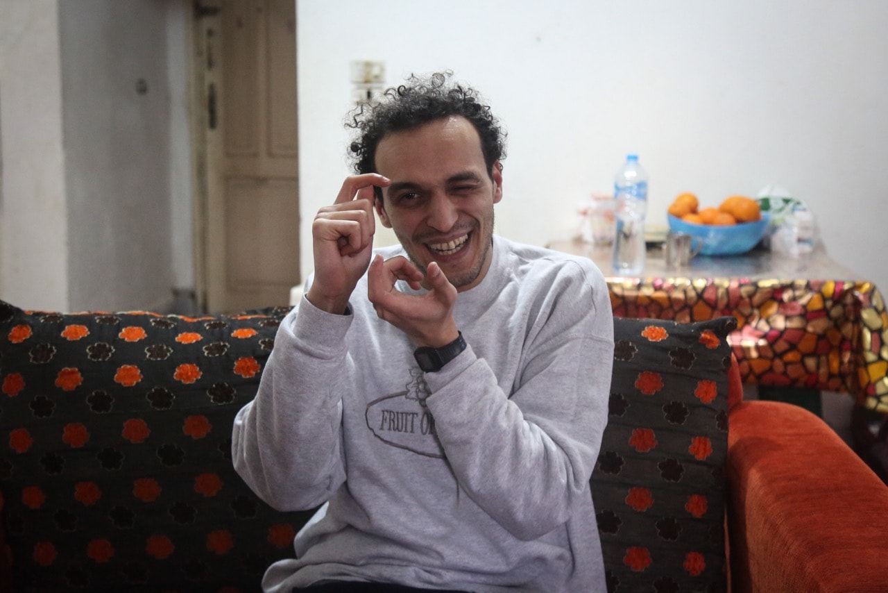Egyptian photojournalist Mahmoud Abu Zeid, also known as 'Shawkan', gestures inside his home after being released, in Cairo, 4 March 2019, Mohamed El Raai/picture alliance via Getty Images