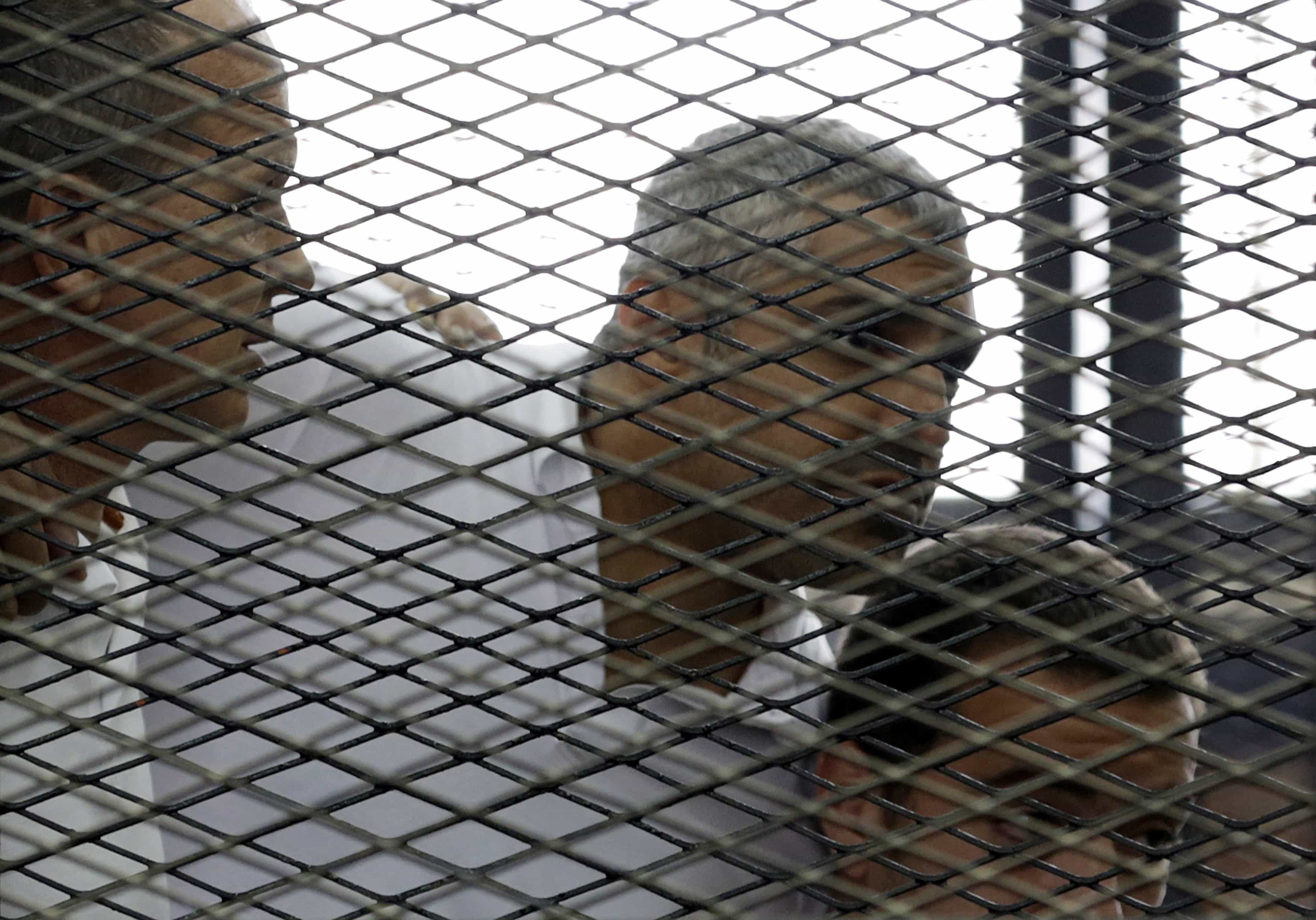 Peter Greste, Mohamed Fahmy and Baher Mohamed (L to R) listen to a ruling at a court in Cairo, 23 June 2014, REUTERS/Asmaa Waguih