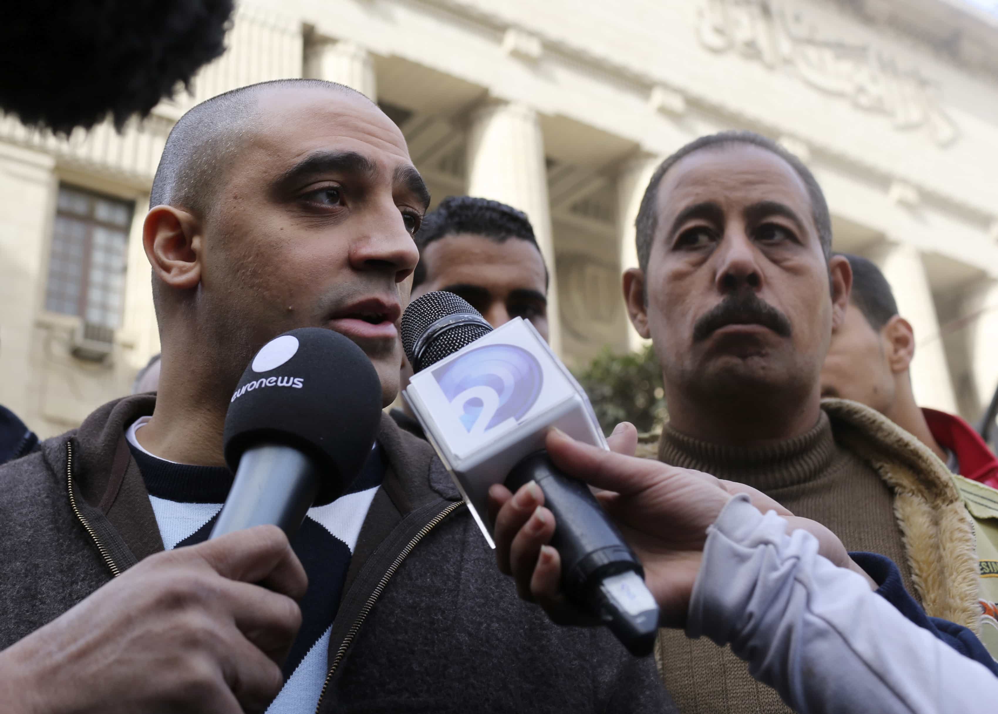 Adel, the brother of Canadian-Egyptian Mohamed Fahmy, one of the imprisoned journalists, speaks to the media in front of a court in Cairo, 1 January 2015, REUTERS/Asmaa Waguih