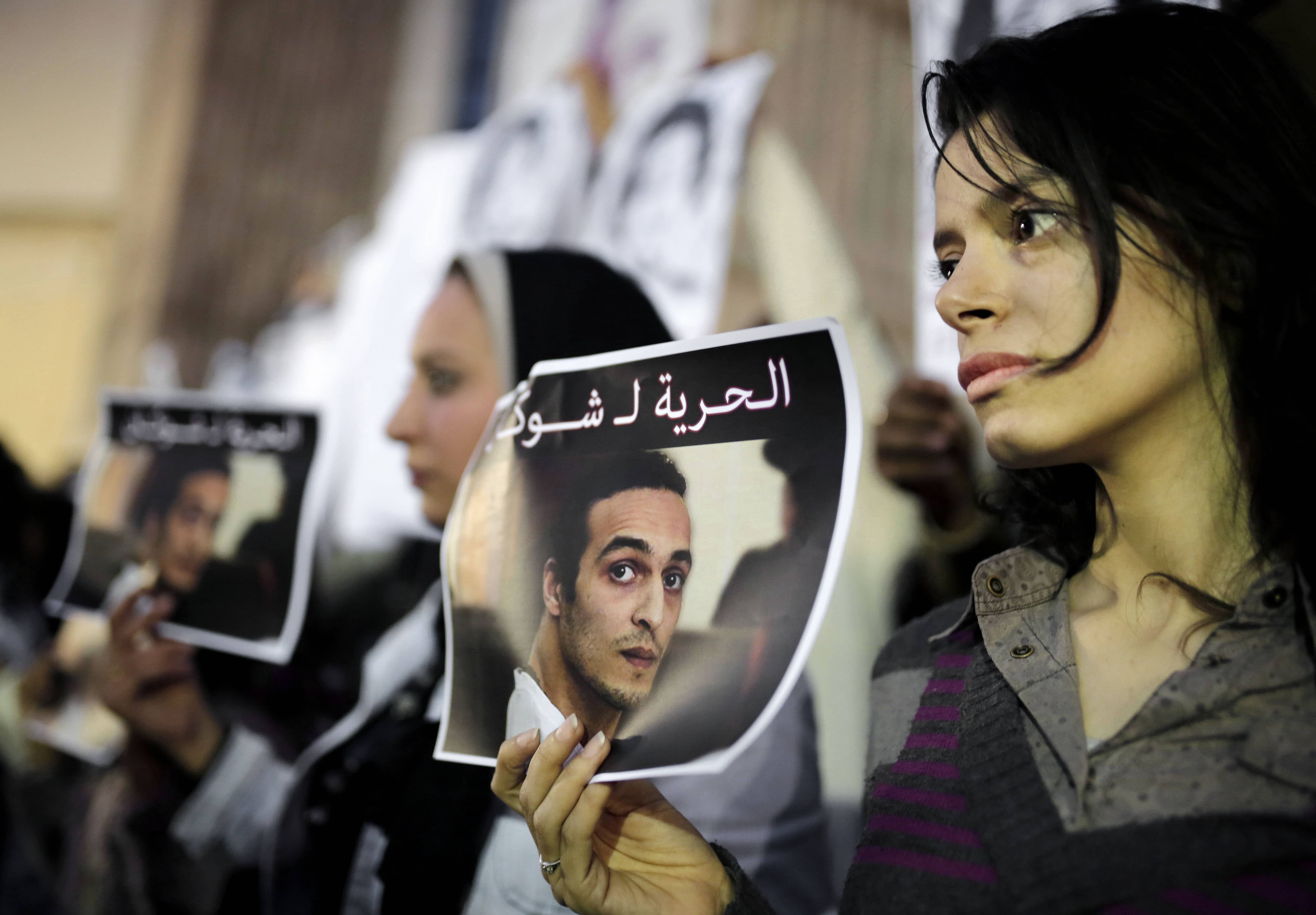 Egyptian journalists hold posters calling for the release from prison detention of Mahmoud Abou-Zeid, known as Shawkan, in front of the Syndicate of Journalists building in Cairo, Egypt, 9 December 2015, AP Photo/Amr Nabil