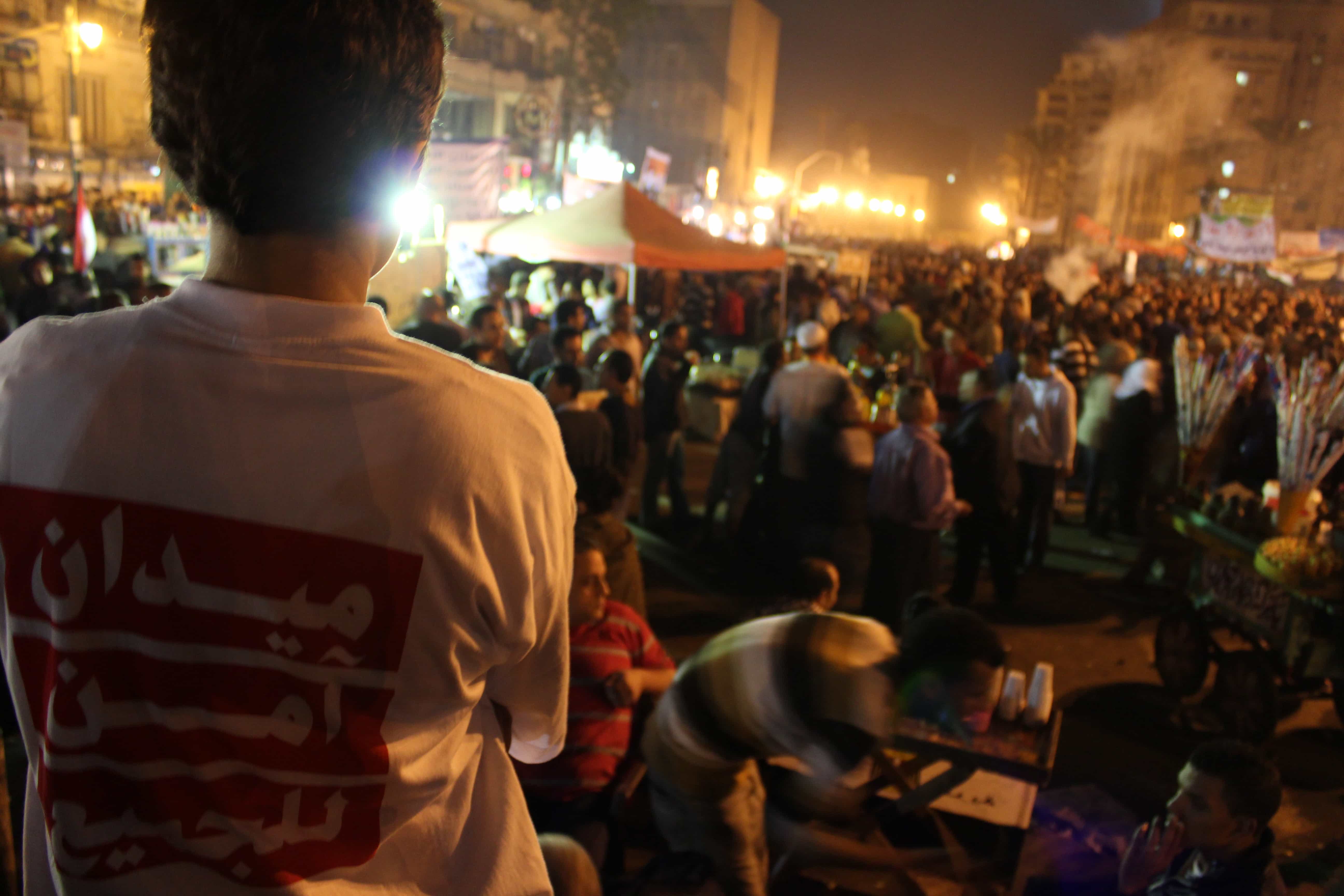 A woman volunteer of OpAntiSH scans Tahrir Square for mob assaults. Her T-shirt reads, 'A safe square for everyone', Sarah El Sirgany