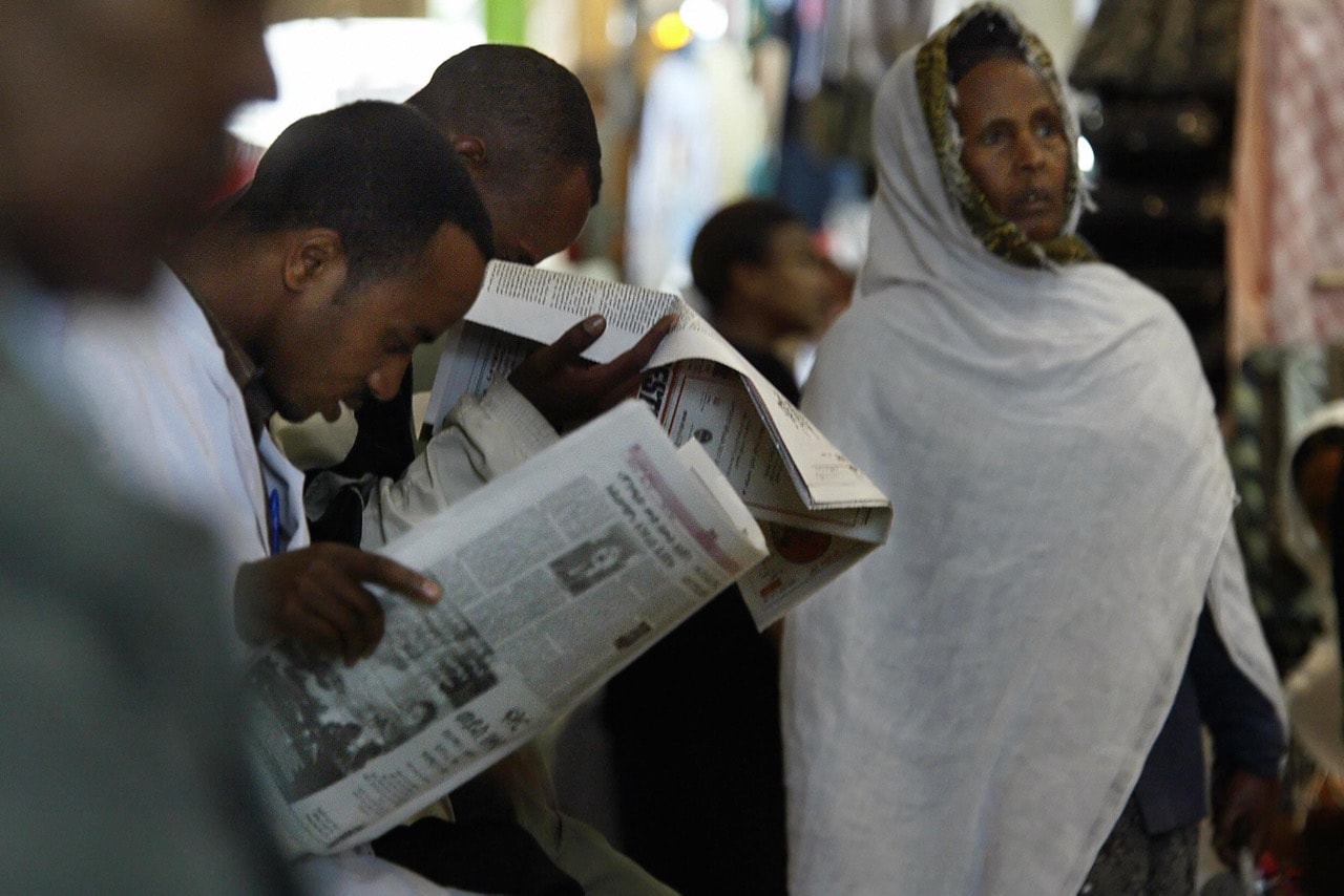 Customers read newspapers in the old Mercato (market) in Addis Ababa, Ethiopia, 14 May 2005, MARCO LONGARI/AFP/Getty Images