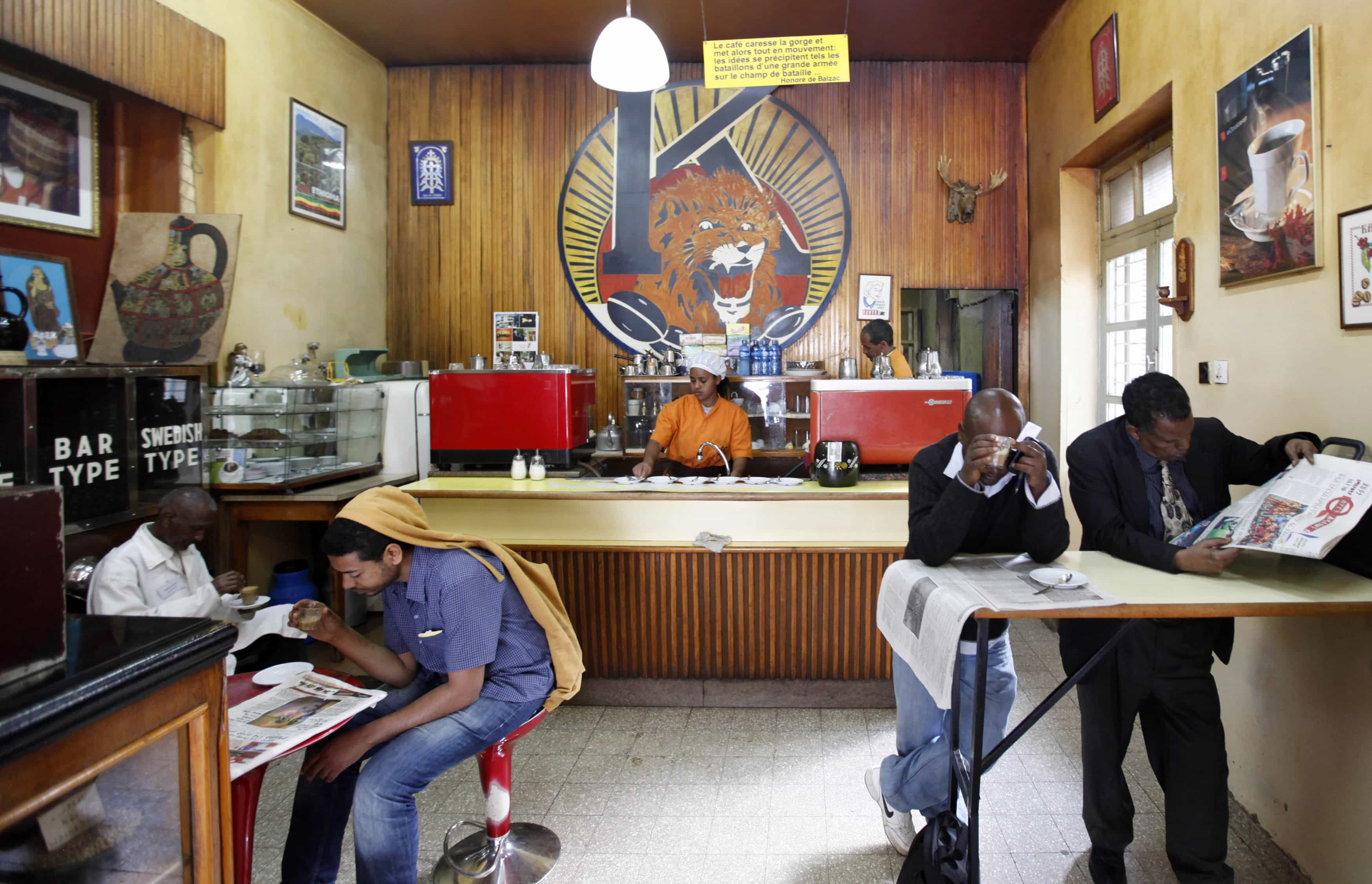 Customers drink coffee as they read newspapers at the Tamoka coffee bar in Addis Ababa, 16 September 2013, Reuters/Stringer
