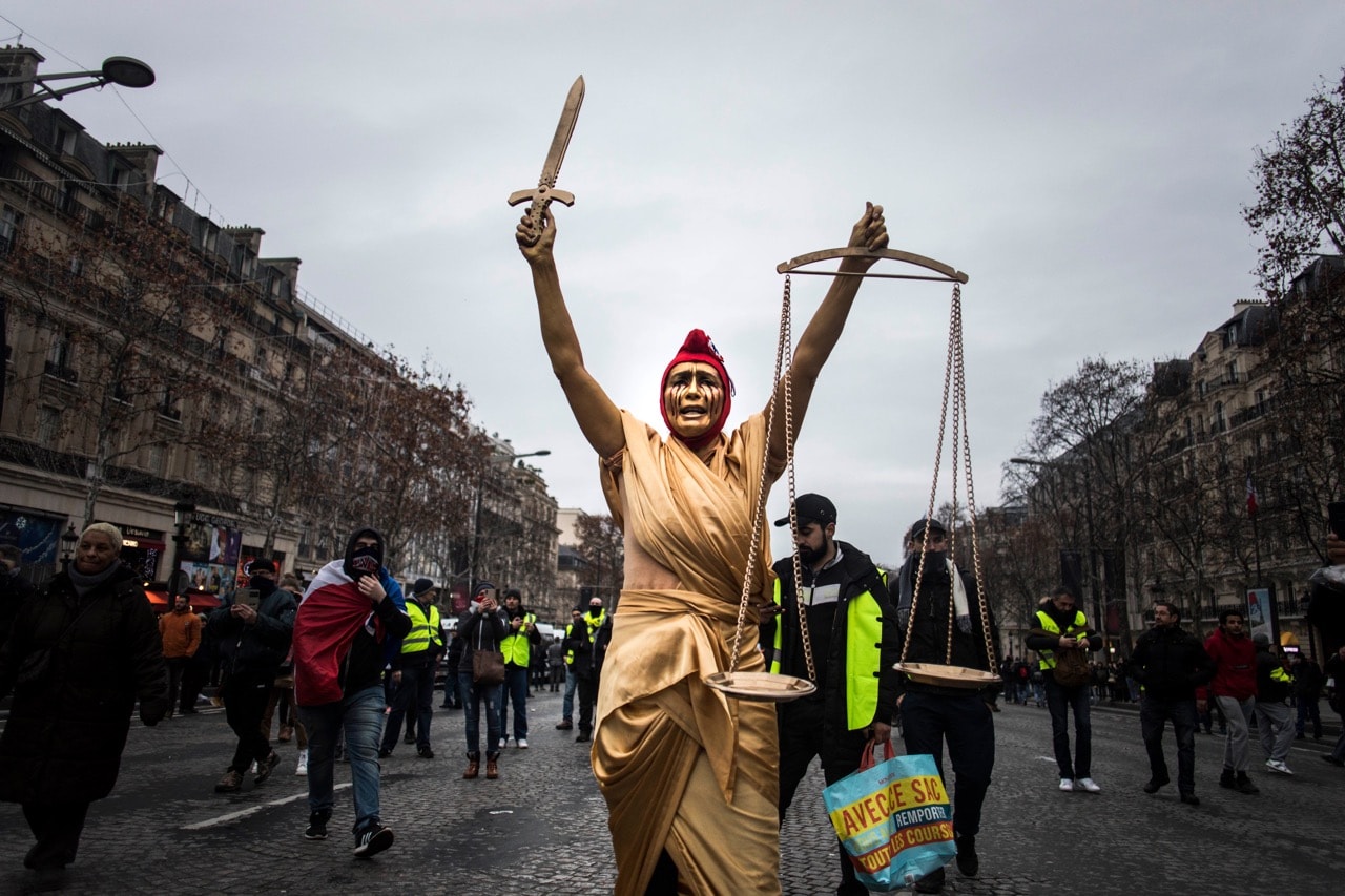 A woman dressed as the French Republic national symbol 'La Marianne' walks on the Champs Elysee during a yellow vest protest, in Paris, France, 29 December 2018, Bruno Thevenin/SOPA Images/LightRocket via Getty Images