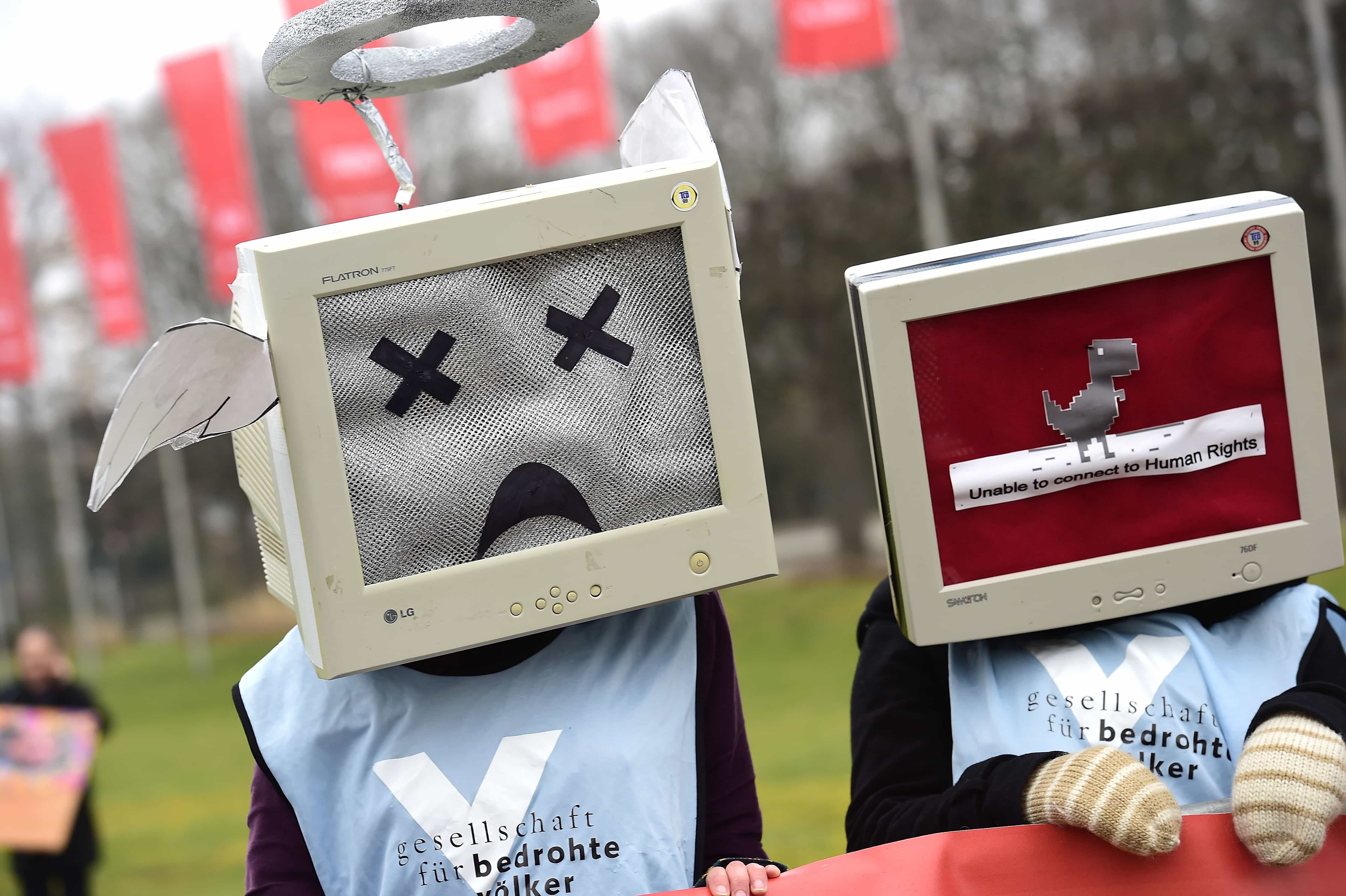 Protesters against internet censorship, wearing computers as helmets, are seen outside the Hanover Congress Centrum in Hanover, Germany, 15 March 2015, Alexander Koerner/Getty Images