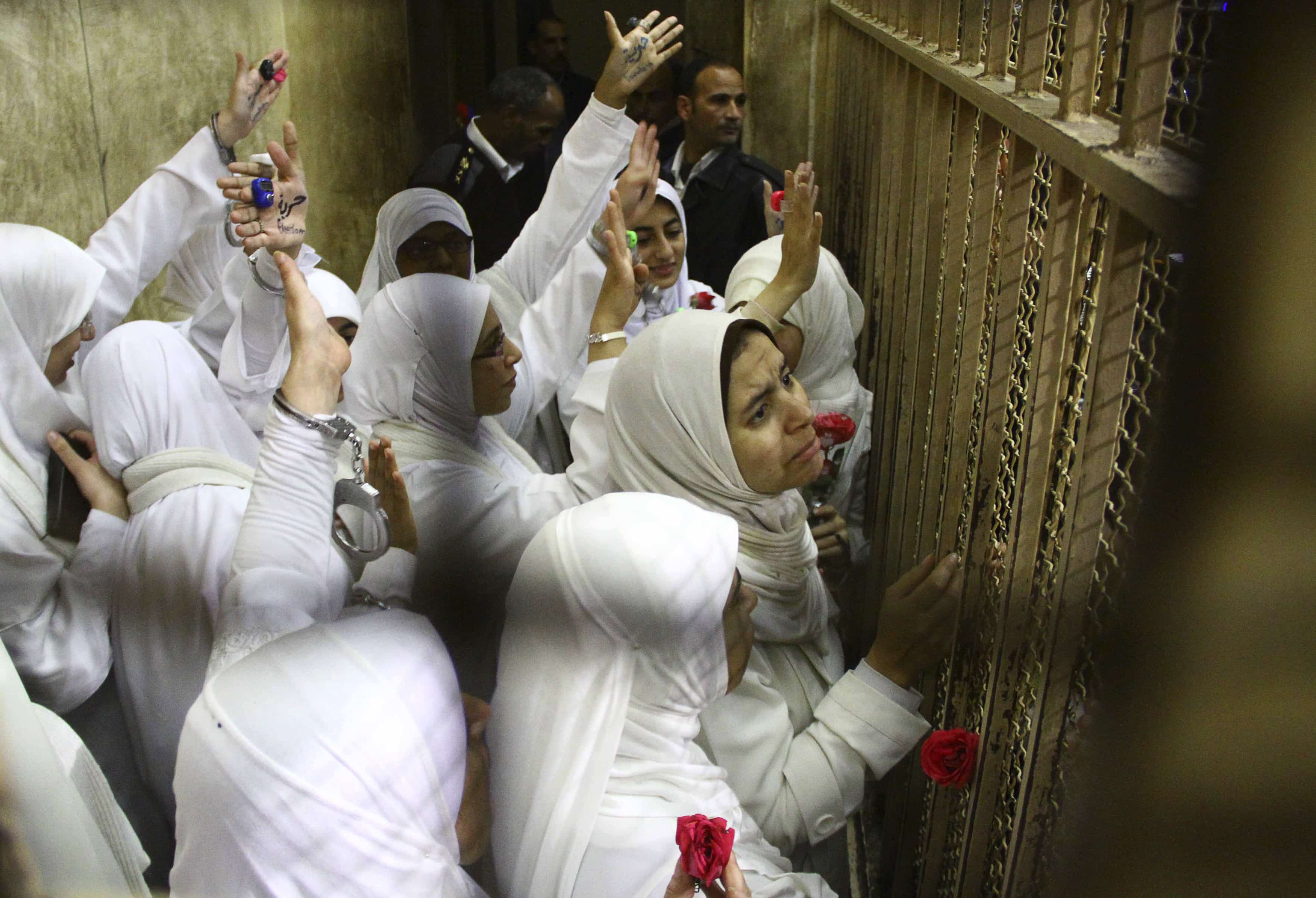 Women, who were found guilty of obstructing traffic during a pro-Islamist protest in October, gesture during their appeal hearing at a court in Alexandria on 7 December 2013, REUTERS/Stringer