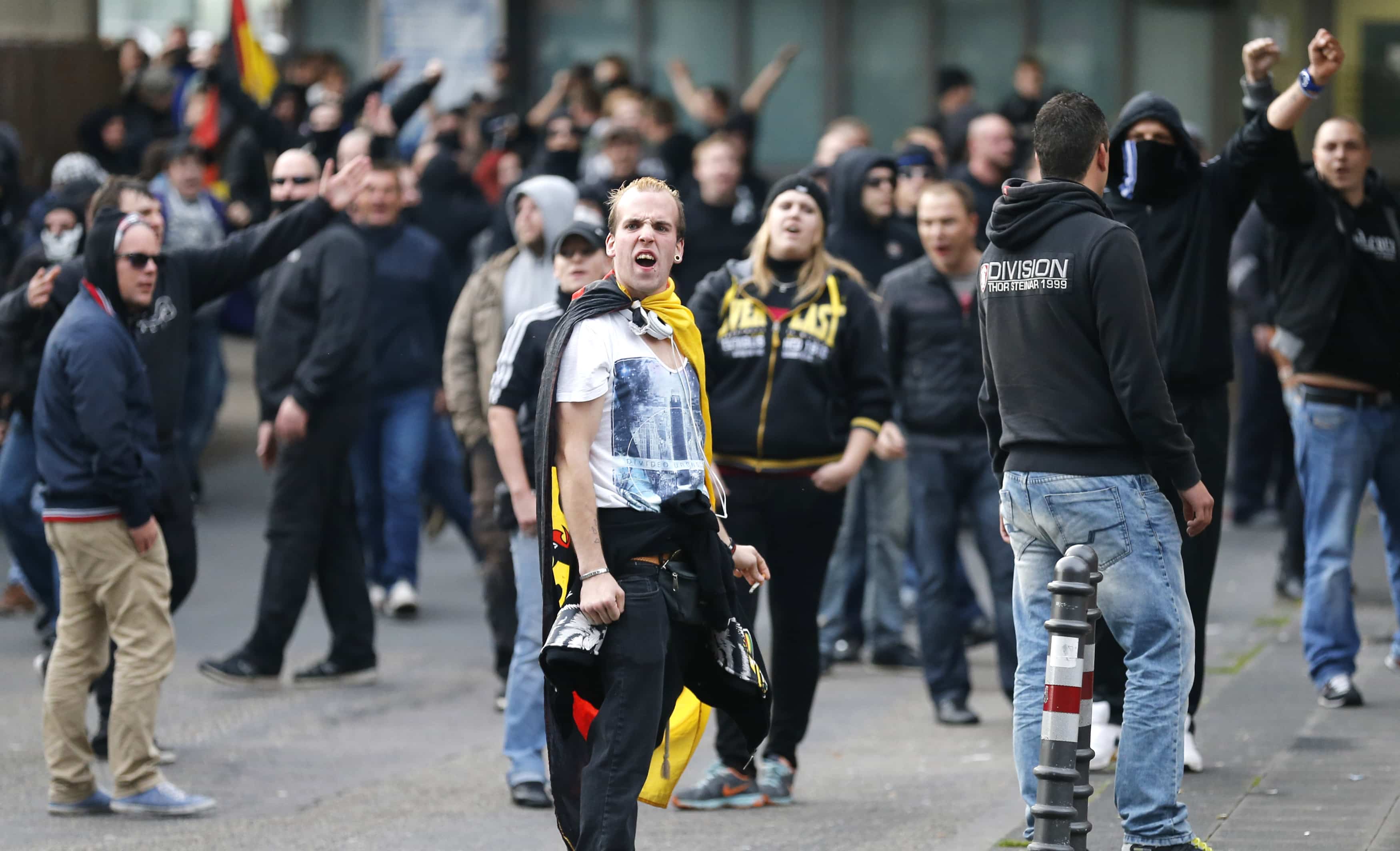 Protesters gesture towards members of the media as they march through the streets of Cologne during a demonstration by German far-right groups, 26 October 2014, REUTERS/Wolfgang Rattay