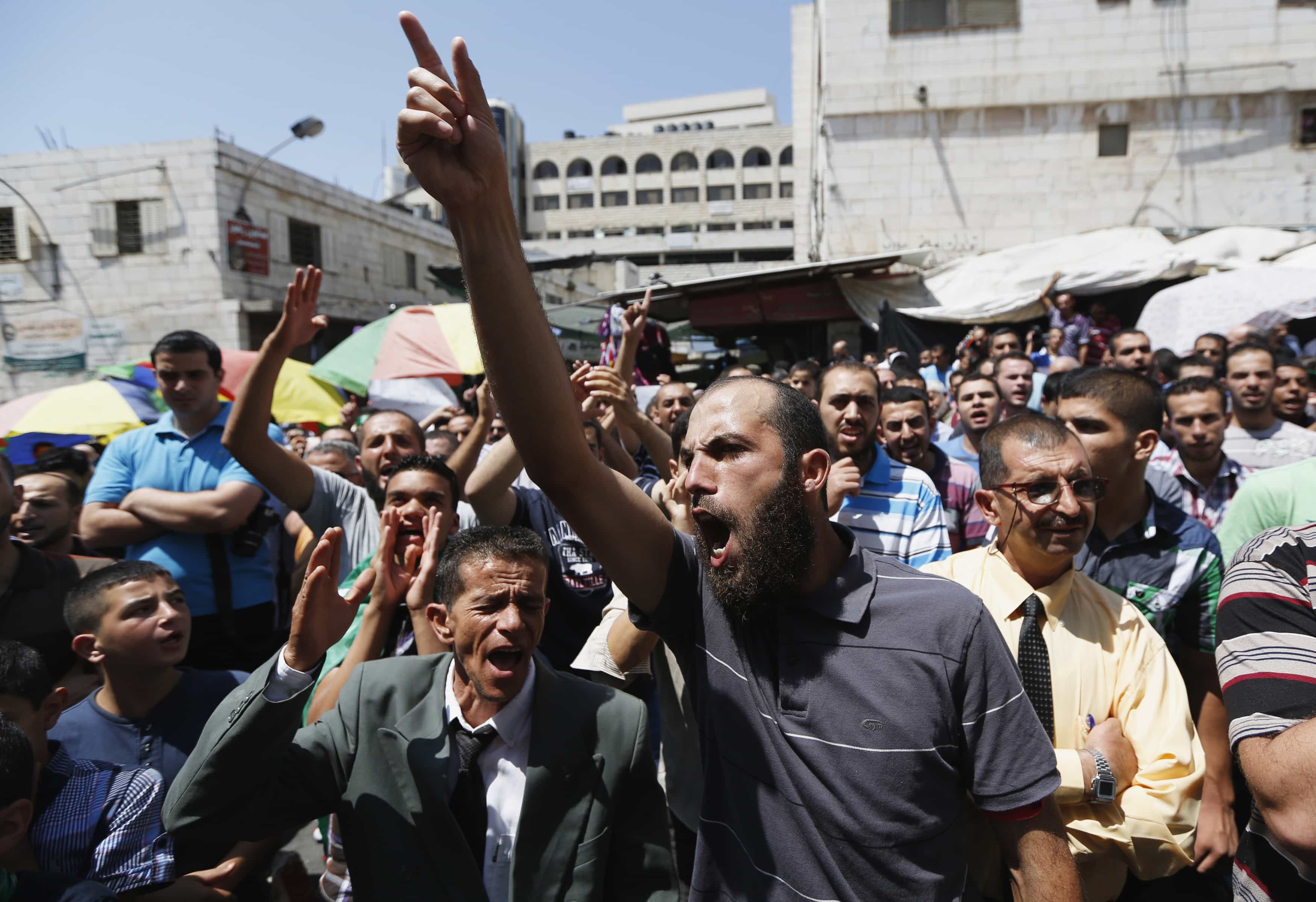 Palestinians shout slogans during a rally in protest of the recent violence in Egypt organized by Hamas in the West Bank on 16 August 2013, REUTERS/Mohamad Torokman