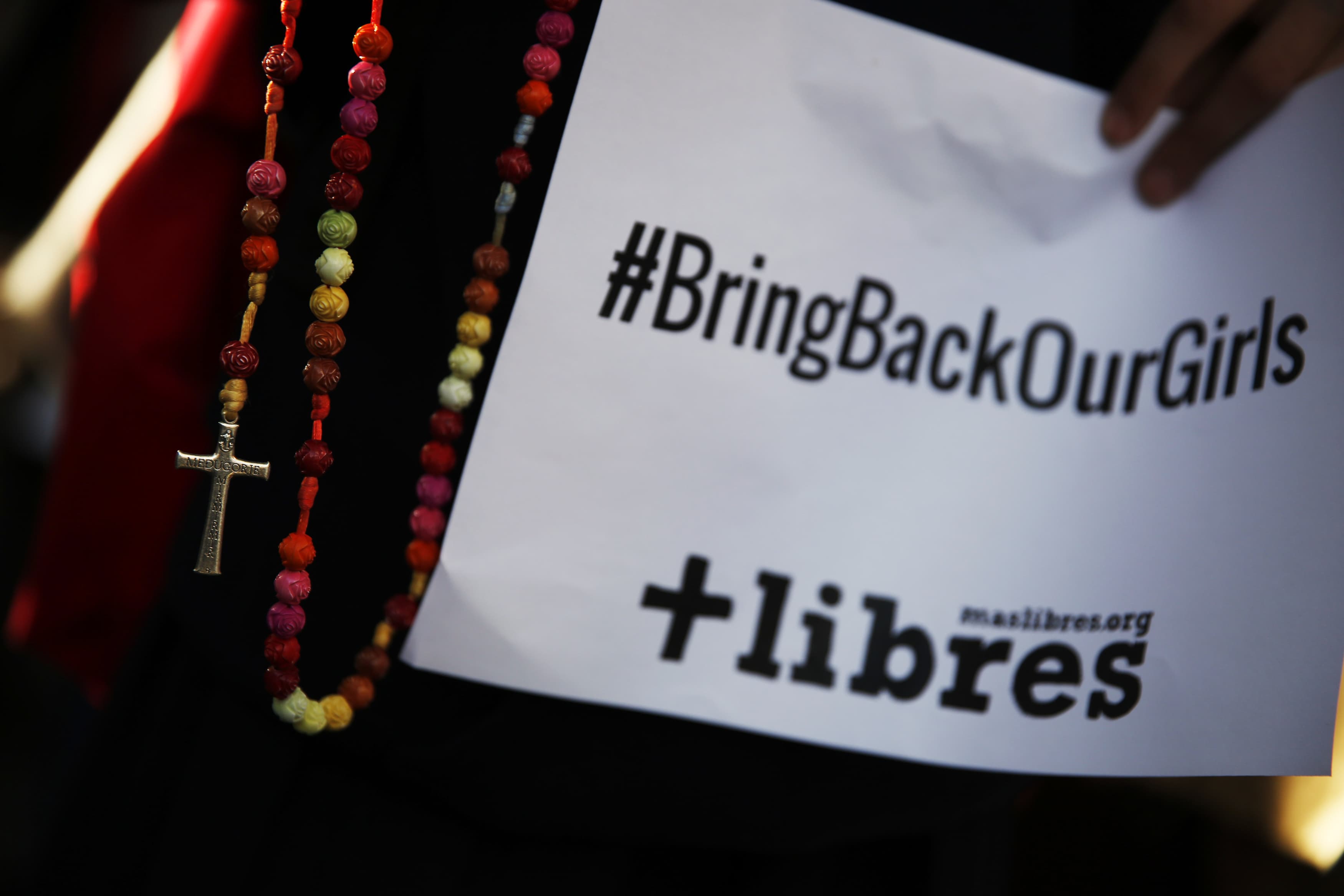 A poster with the Twitter campaign hashtag #BringBackOurGirls is seen during a prayer vigil showing support for Nigerian schoolgirls abducted by militant group Boko Haram, outside the Nigerian Embassy in Madrid May 22, 2014, REUTERS/Susana Vera