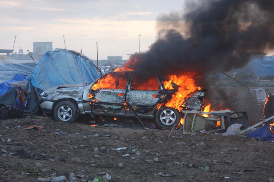 A car burns after Iraqi security forces raided a public square in Haweeja killing 45 people on 23 April 2013, Human Rights Watch