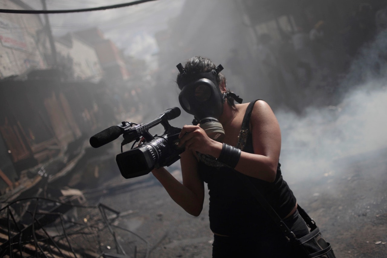 A member of the local media reporting in Tegucigalpa, Honduras, 18 February 2012, REUTERS/Jorge Dan Lopez