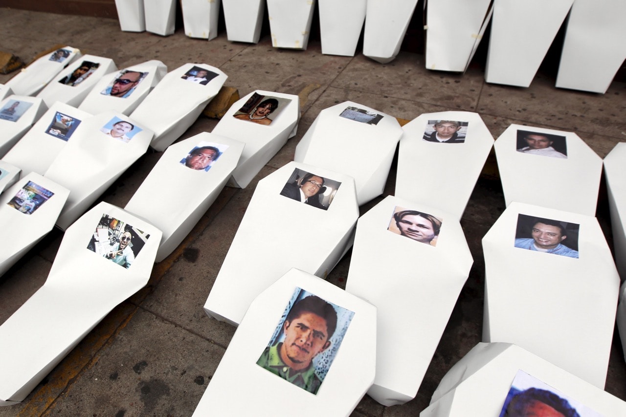 Paper coffins, symbolising slain journalists, are seen lined up during a protest to demand justice for them in Tegucigalpa, Honduras, 11 April 2016, REUTERS/Jorge Cabrera