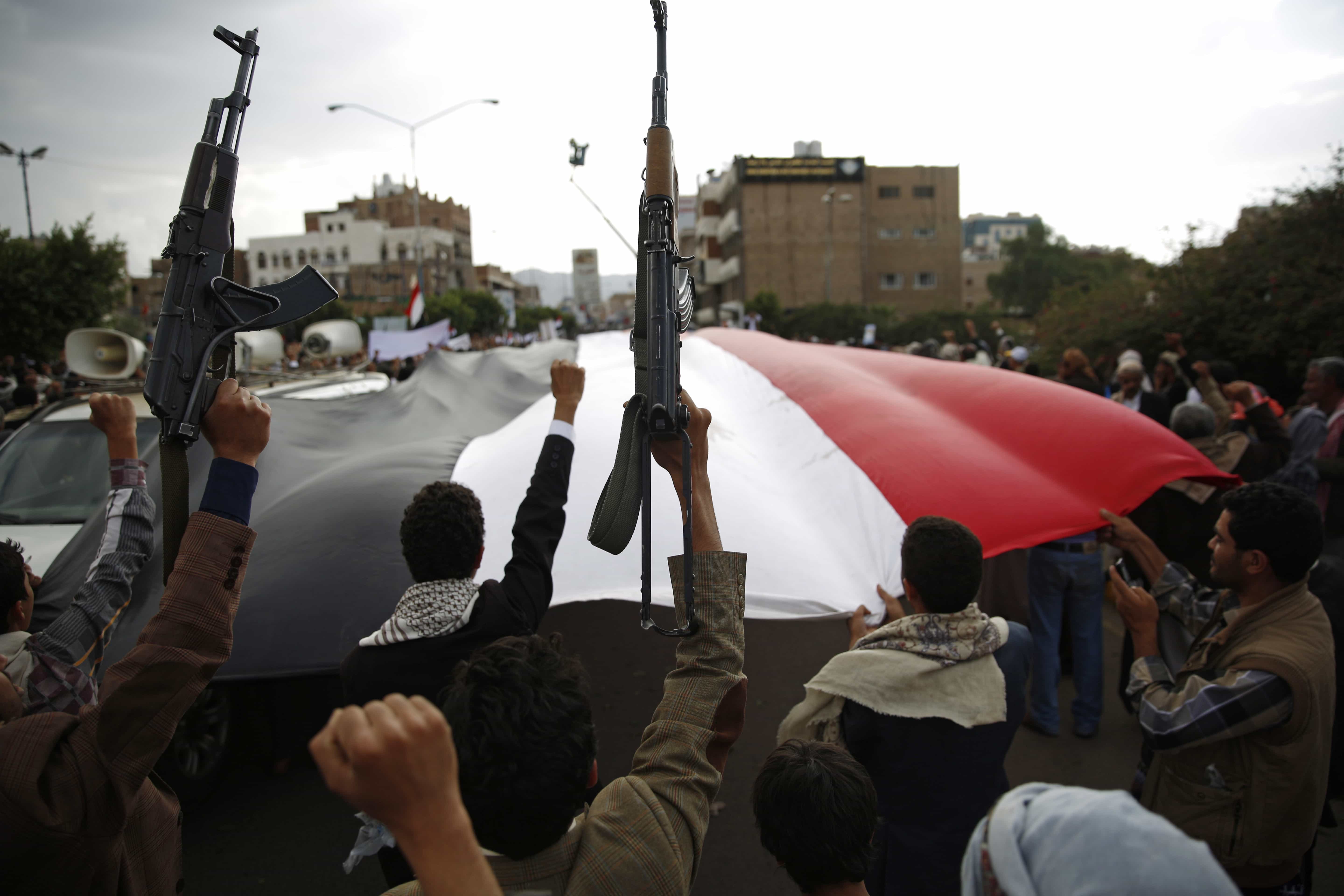 Shiite rebels known as Houthis hold up their weapons as they chant slogans during a rally to protest Saudi-led airstrikes, in Sanaa, Yemen, AP Photo/Hani Mohammed