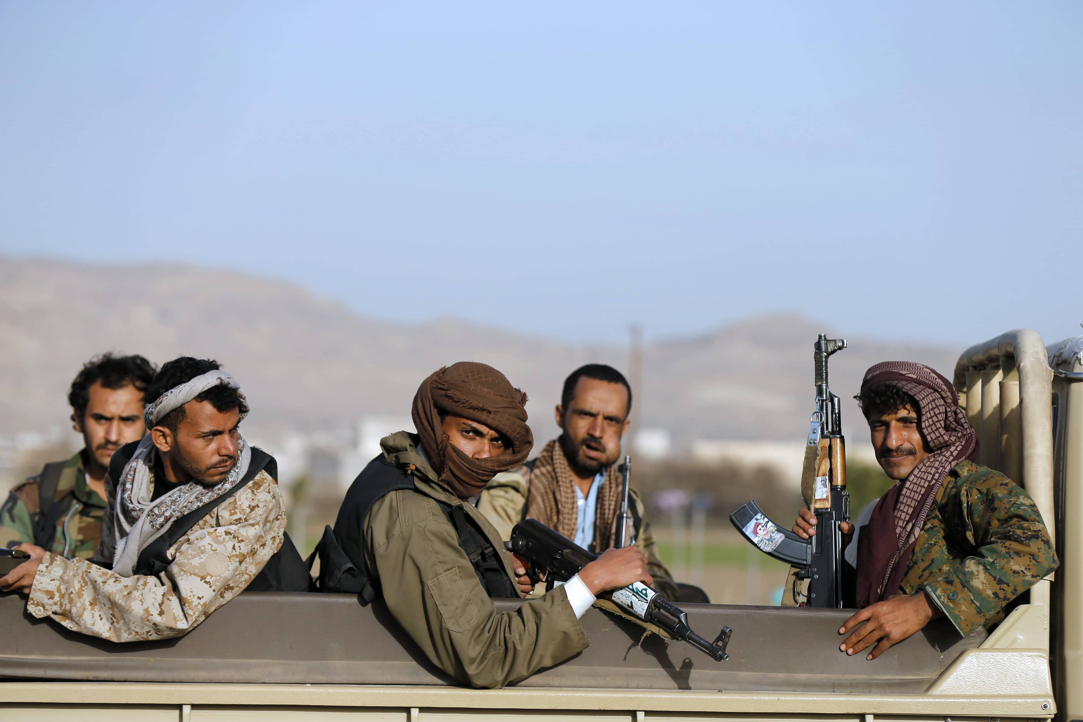 Houthi fighters ride a truck near the presidential palace in Sanaa January 22, 2015, REUTERS/Khaled Abdullah