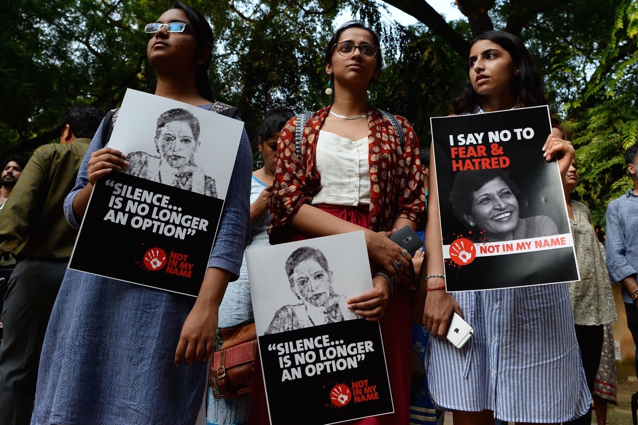 Demonstrators hold placards with the picture of journalist Gauri Lankesh during a 'Not In My Name' protest in New Delhi, India, 6 September 2017, SAJJAD HUSSAIN/AFP/Getty Images