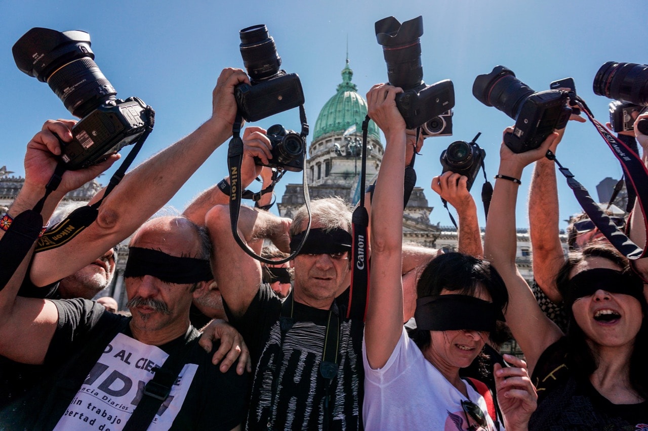 Photojournalists raise their cameras during a protest against the closure of the private news agency Diarios y Noticias (DYN), in front of the National Congress in Buenos Aires, Argentina, 14 November 2017, EITAN ABRAMOVICH/AFP/Getty Images