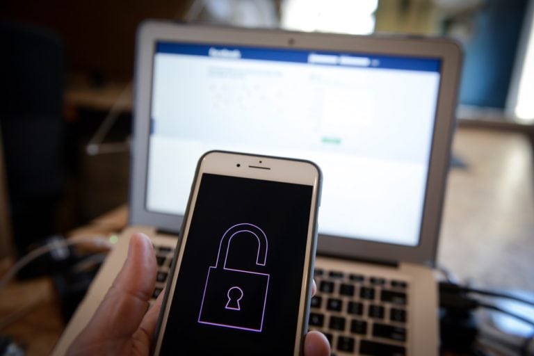 A phone with a lock symbol is seen in front of a computer screen, 7 June 2018, Jaap Arriens/NurPhoto via Getty Images