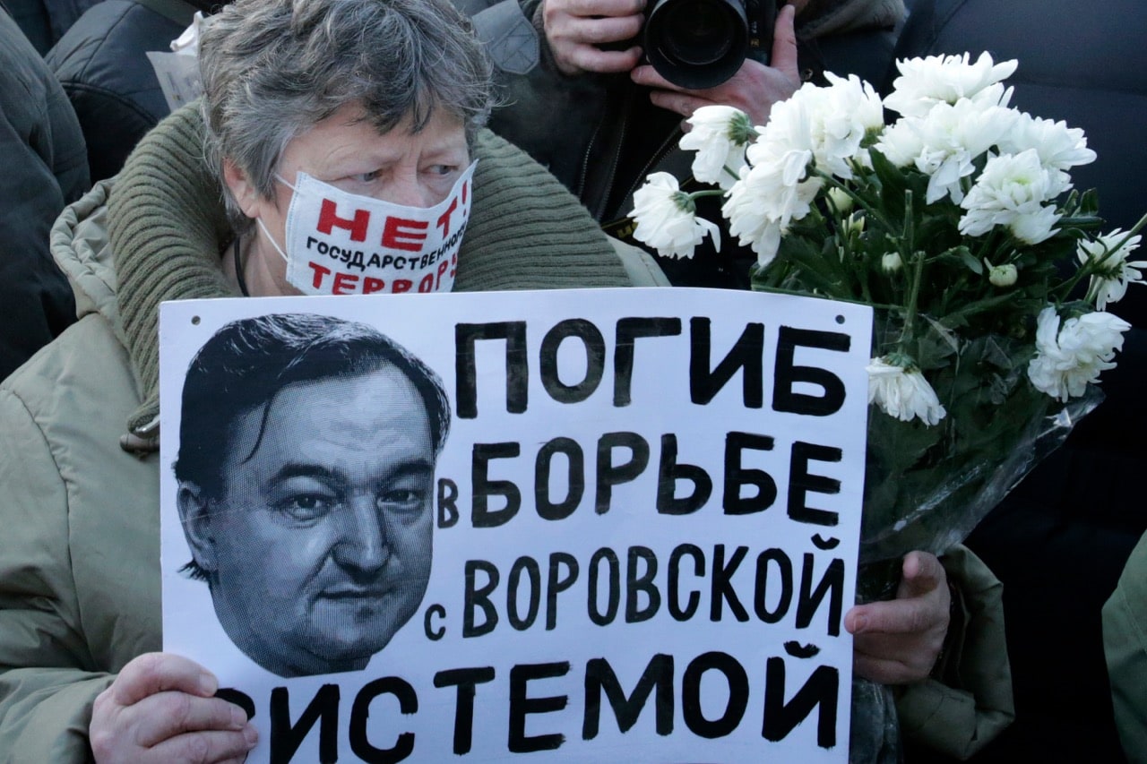 A woman holds a placard with a portrait of Sergei Magnitsky during an unauthorised rally in central Moscow, Russia, December 15, 2012. The placard reads "Dead in the fight against the system of thievery", REUTERS/Tatyana Makeyeva