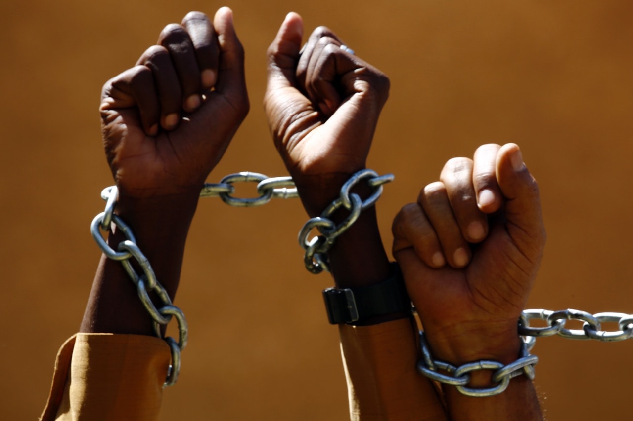 Sudanese journalists pose with chains to protest a decision impeding the publication of "Tayar" newspaper, in Khartoum, 1 March 2016, ASHRAF SHAZLY/AFP/Getty Images