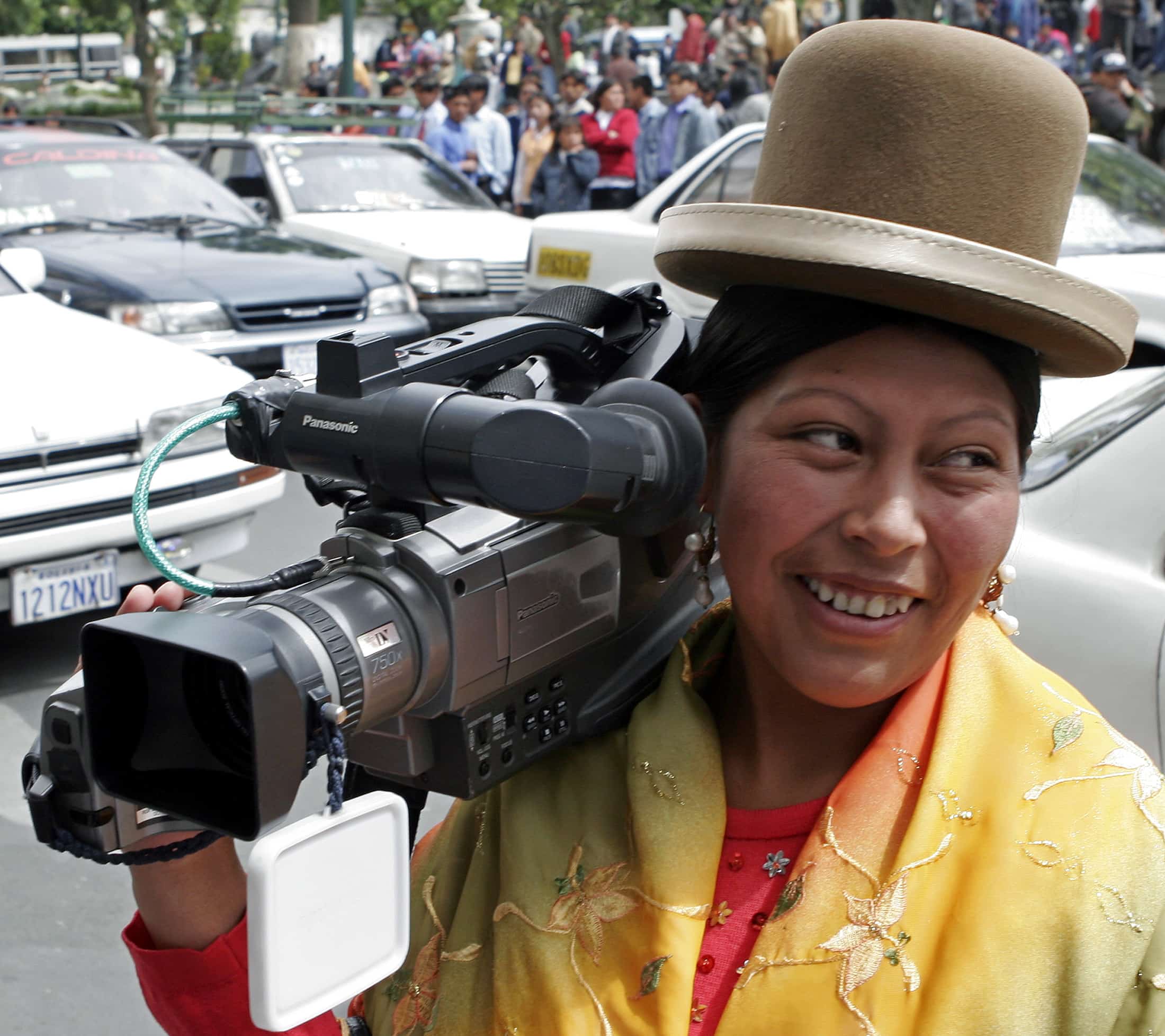 An indigenous Bolivian camerawoman waits for news in front of the presidential palace in La Paz, 26 October 2006, REUTERS/David Mercado