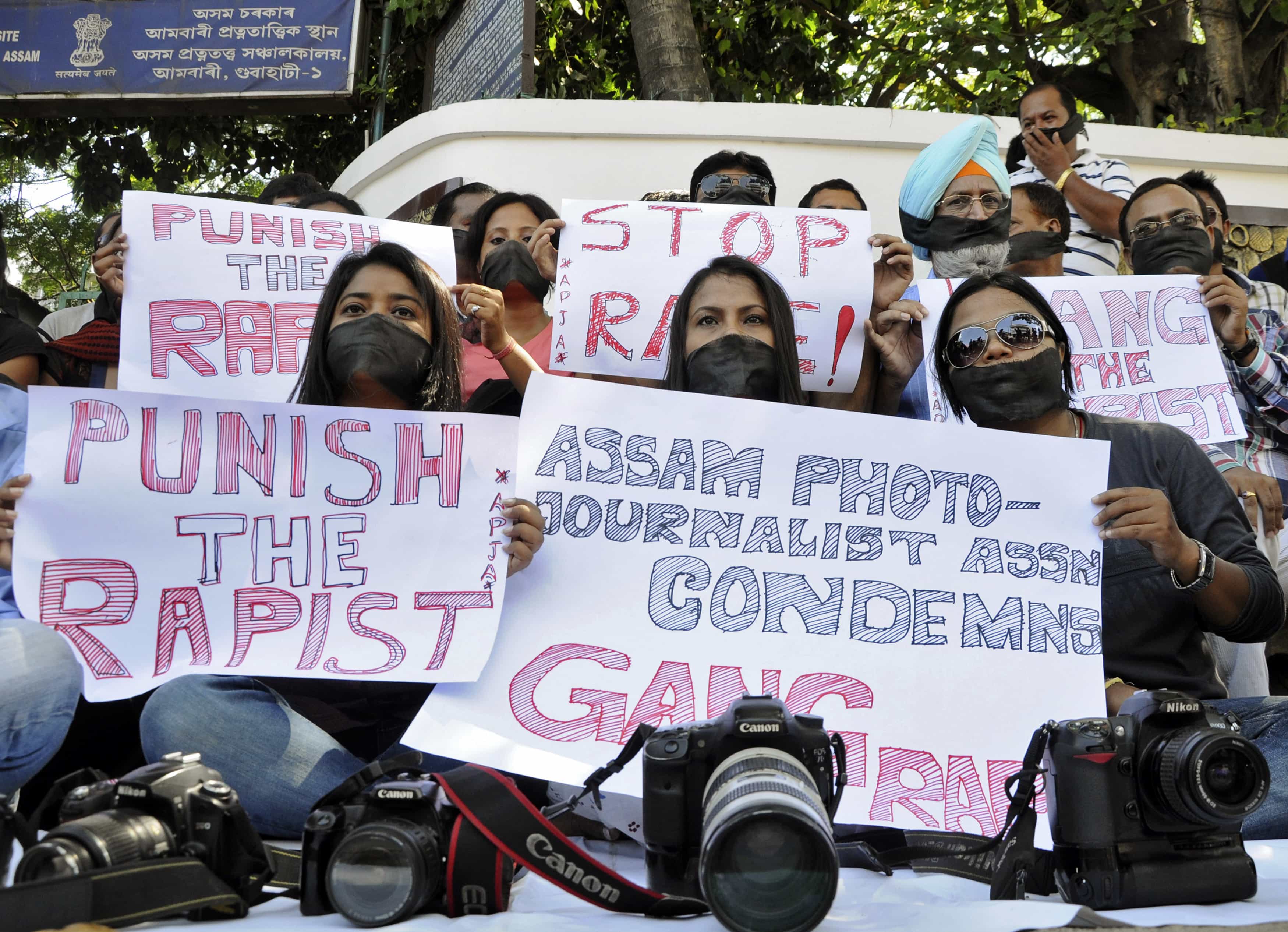 Members of the All Assam Photojournalists Association wear black sashes across their mouths during a 24 August 2013 protest against the rape of a female photojournalist in Mumbai, REUTERS/Utpal Baruah
