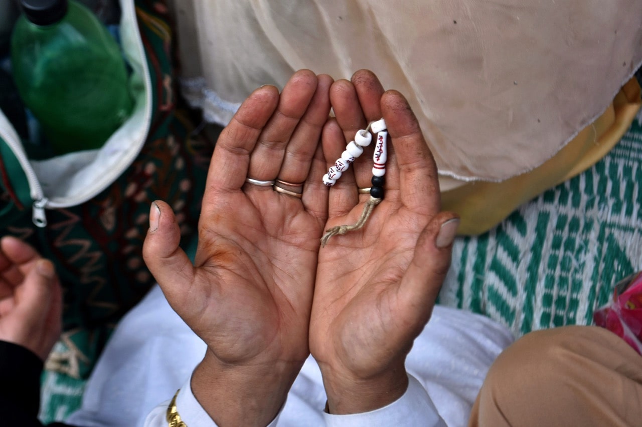 A woman raises her hands in prayer at a Sufi shrine in Kahsmir, India, 29 August 2017, Saqib Majeed / Barcroft Images / Barcroft Media via Getty Images