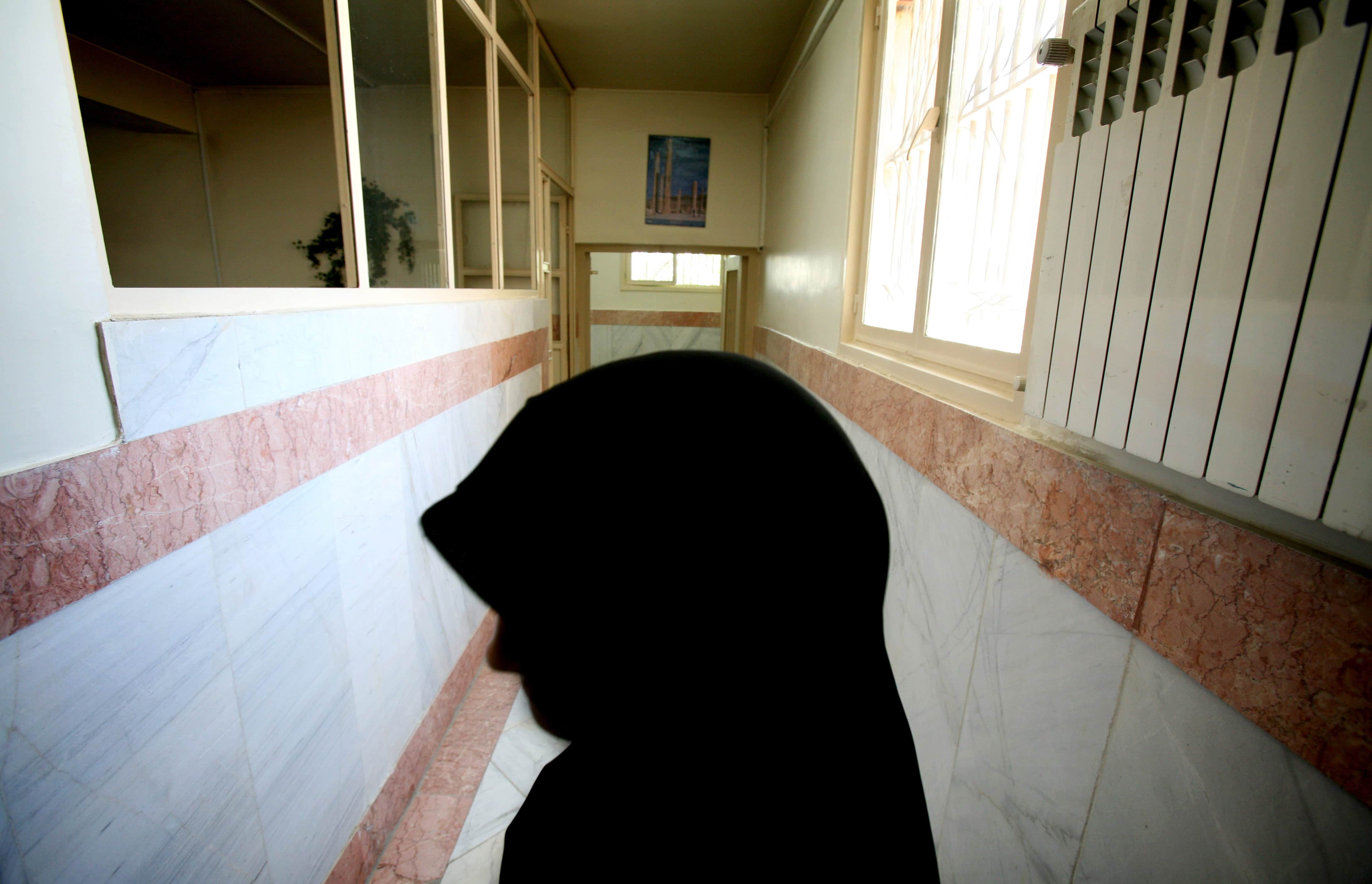 In this 2006 photo, a female prison guard stands along a corridor in Tehran's Evin prison