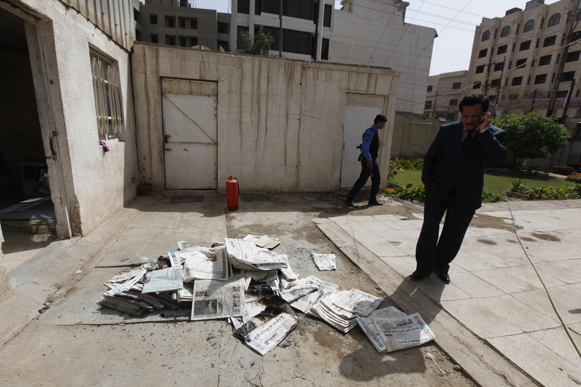 An Iraqi journalist stands near the archive newspapers burned when an armed group attacked "Addustour" newspaper in Baghdad, 2 April 2013; Iraq has an appalling record of not prosecuting attacks on journalists, REUTERS/Thaier al-Sudani