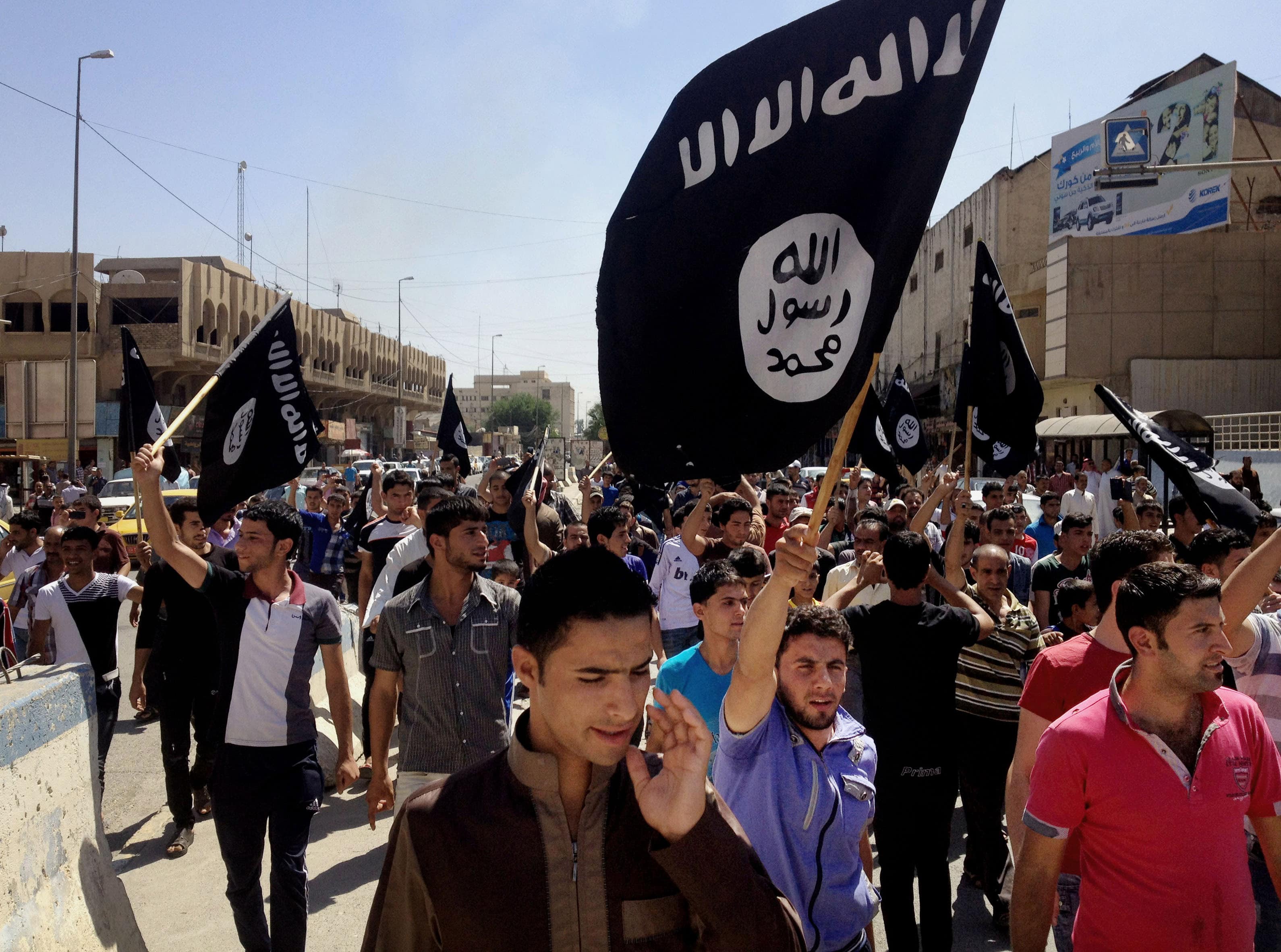 In this June 2014 file photo, demonstrators chant pro-Islamic State group slogans as they wave the group's flags in front of the provincial government headquarters in Mosul, AP Photo, File