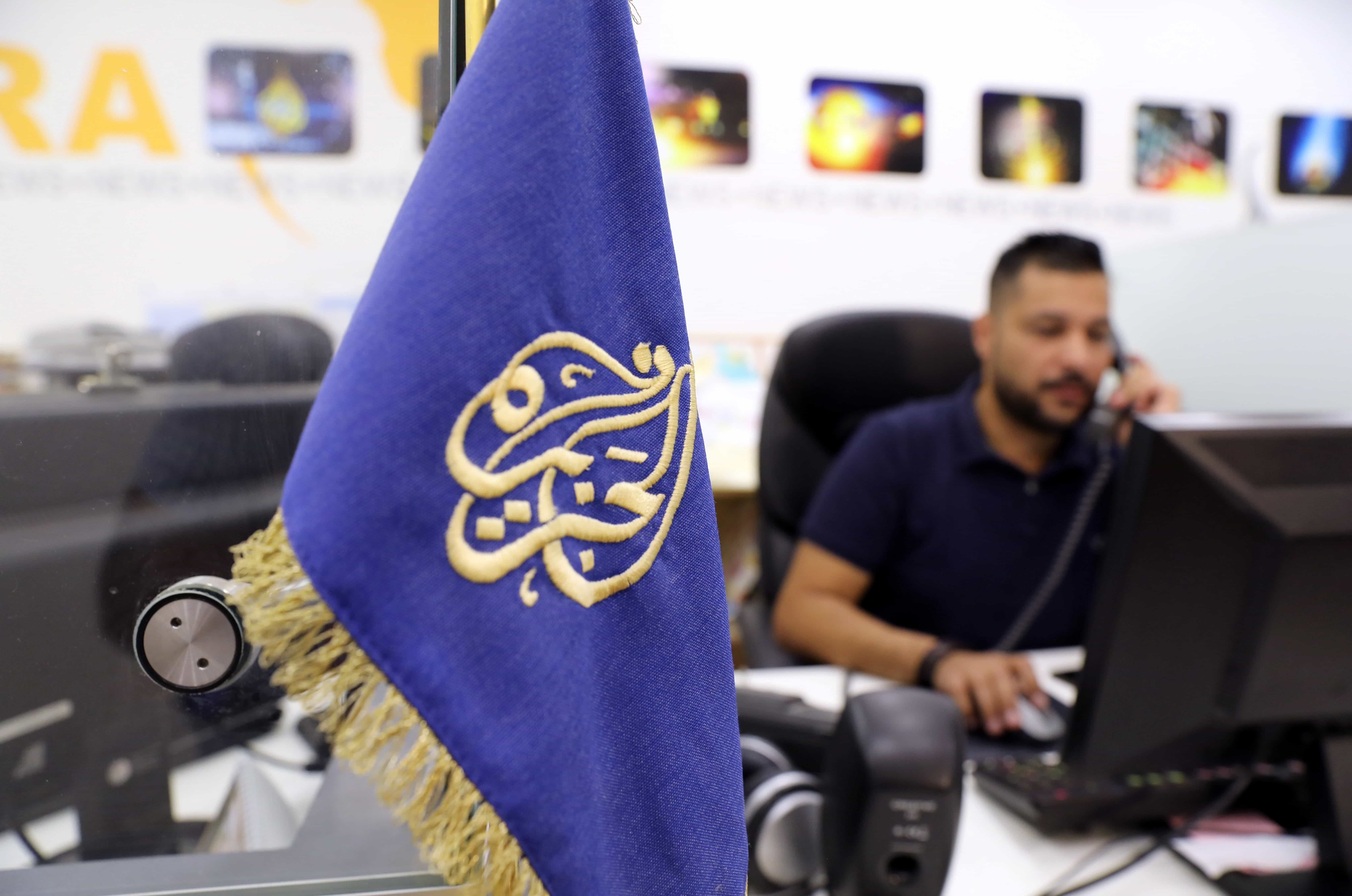 An employee works inside the office of the Qatar-based Al-Jazeera network in Jerusalem, 7 August 2017, REUTERS/Ammar Awad