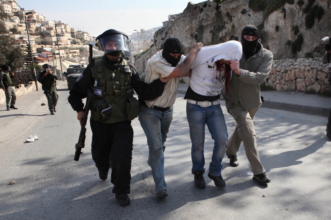 Israeli riot police and undercover policemen arrest a Palestinian protester during clashes in the mostly Arab East Jerusalem neighborhood of Silwan, 28 January 2011, GALI TIBBON/AFP/Getty Images