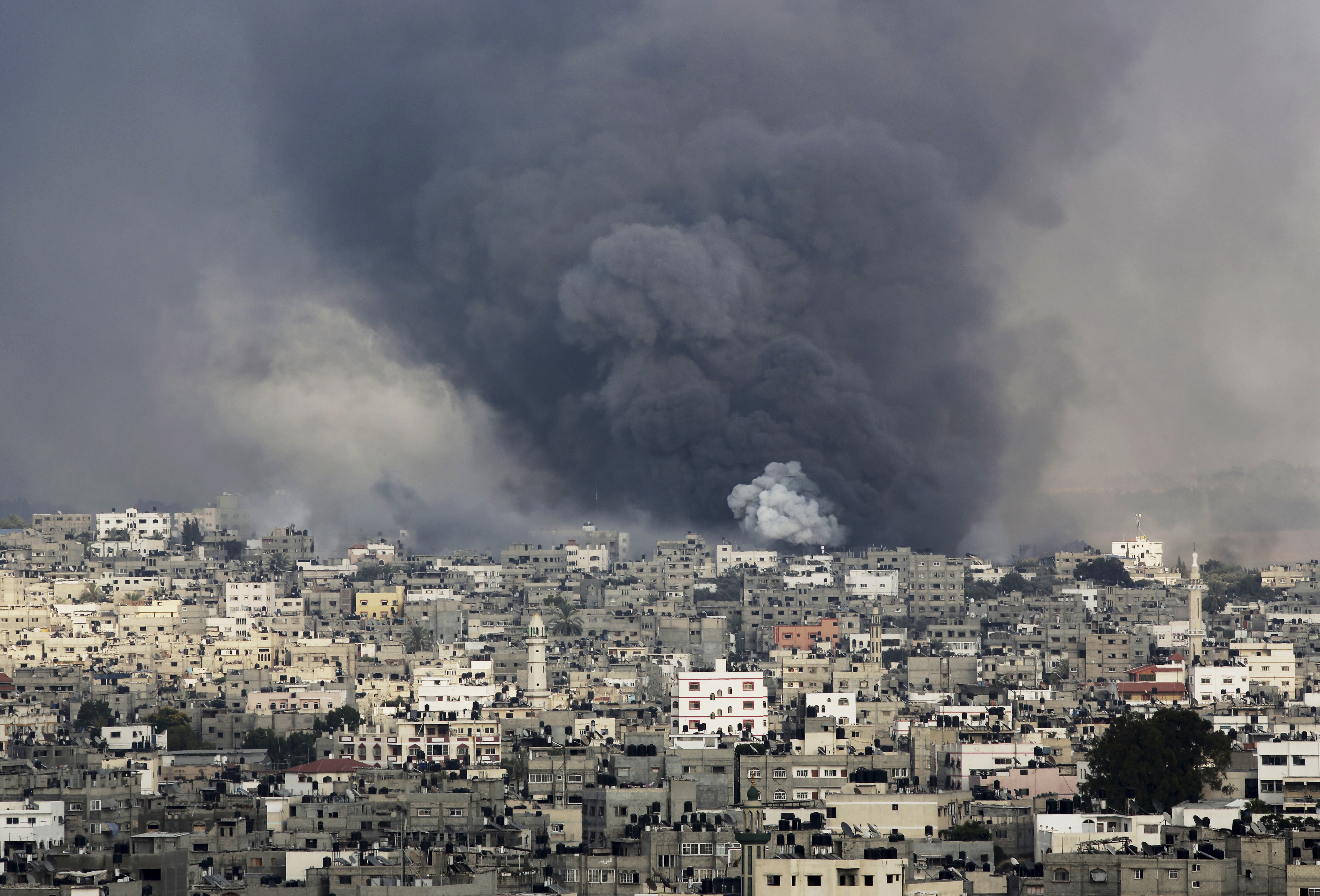 Smoke rises from explosions caused by an Israeli missile strike in the Shijaiyah neighborhood in Gaza City on 20 July, AP Photo/Adel Hana