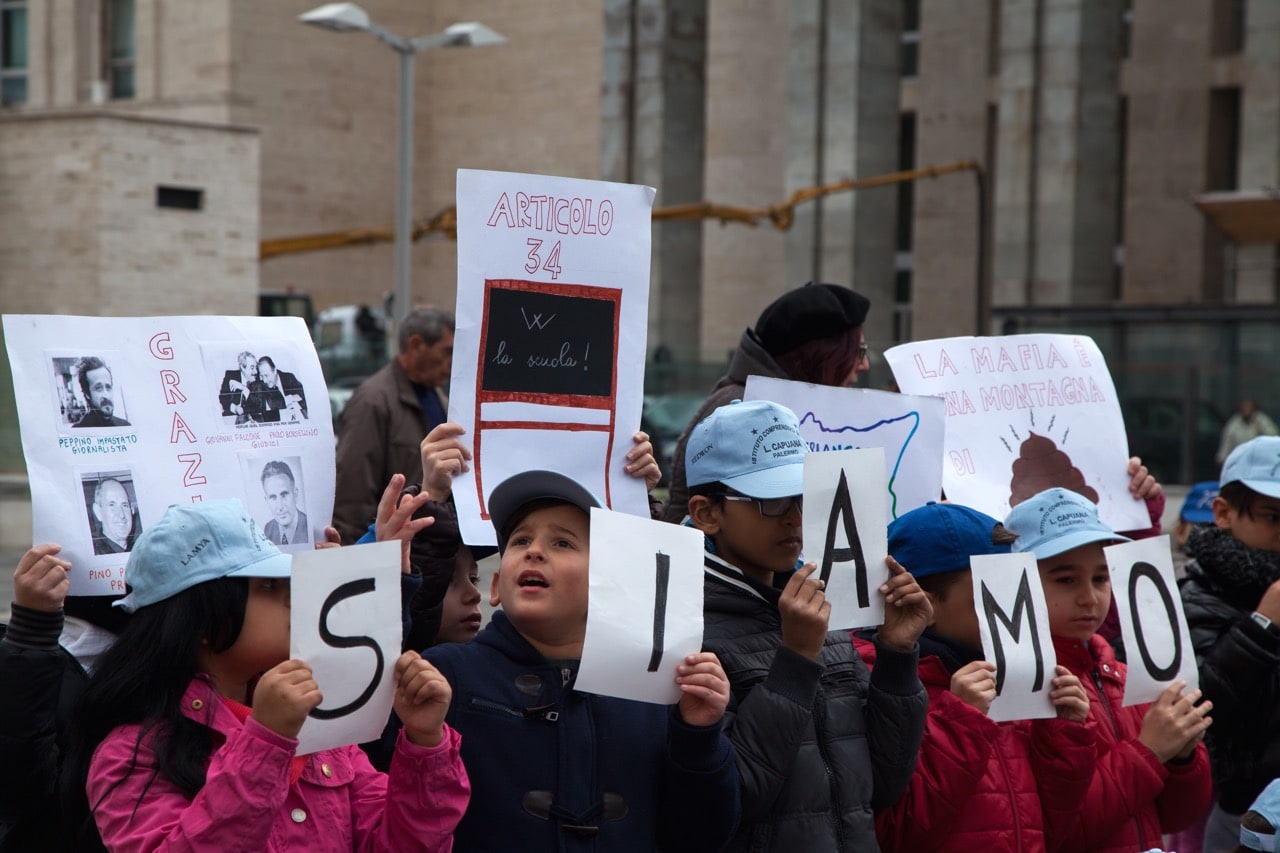 Children hold placards in front of the Palace of Justice in Palermo, Sicily, to show support for anti-Mafia magistrates, 20 January 2016, Melita Antonio/Pacific Press/LightRocket via Getty Images