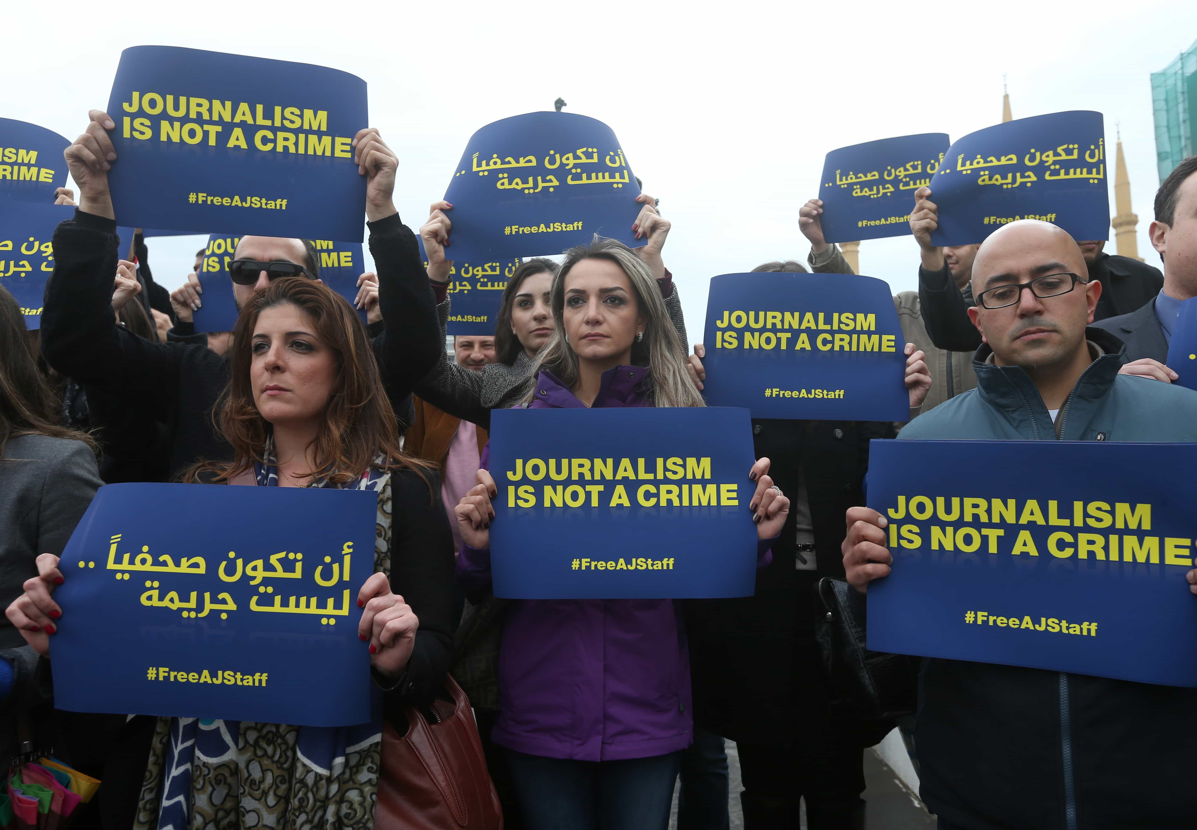 Journalists in Lebanon hold placards, to show their solidarity with detained journalists by Egyptian authorities during a sit-in on 27 February 2014, AP Photo/Hussein Malla
