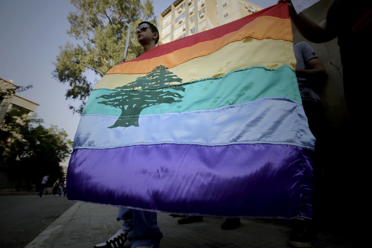 A gay pride flag bearing the cedar tree in the middle of it is carried by human rights activists during an anti-homophobia rally in Beirut, Lebanon, 30 April 2013, JOSEPH EID/AFP/Getty Images