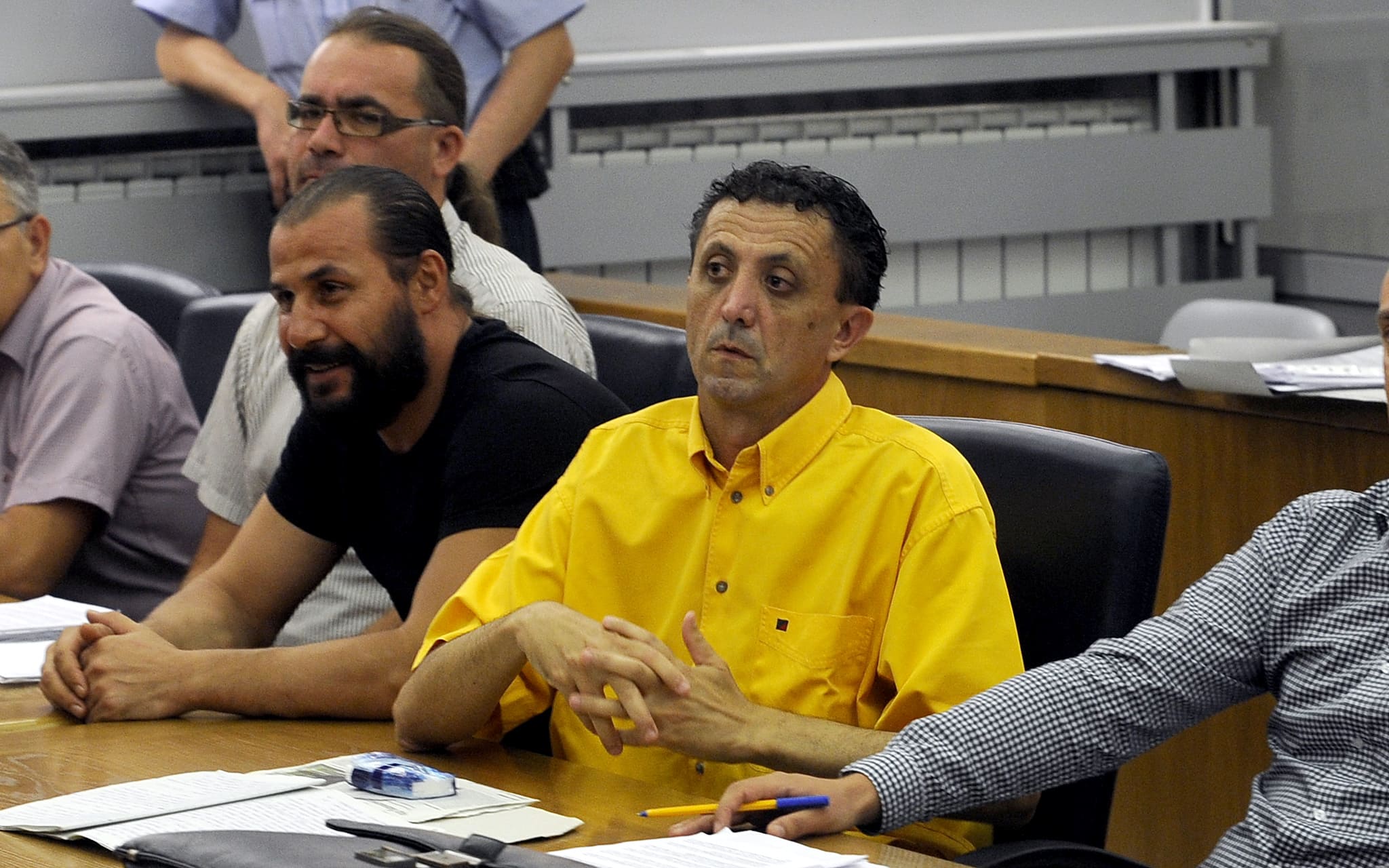 Tomislav Kezarovski, centre, attends trial in Skopje on 9 August 2013., AP Photo/Boris Grdanoski