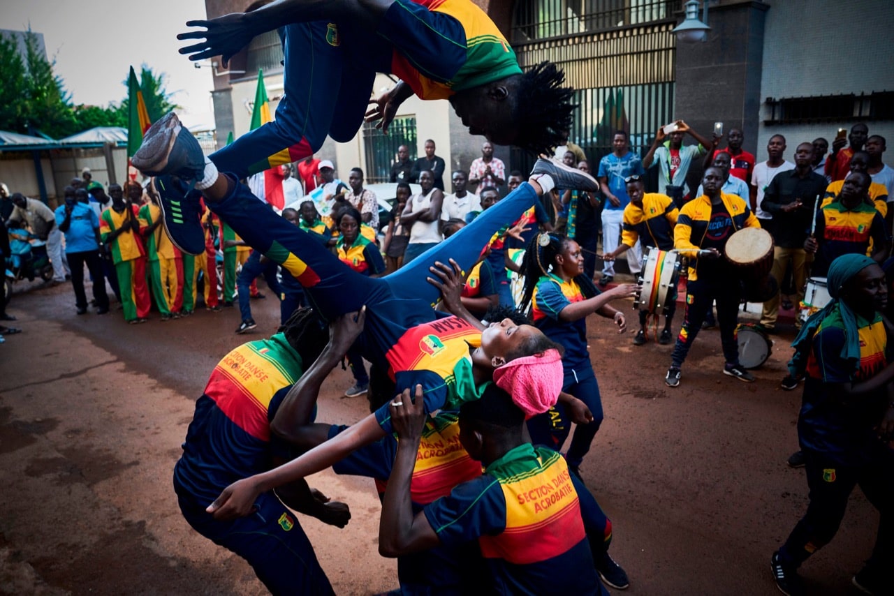 Acrobats perform outside the headquarters of Mali's incumbent president and candidate for re-election in Bamako, 13 August 2018, one day after a presidential runoff vote, MICHELE CATTANI/AFP/Getty Images