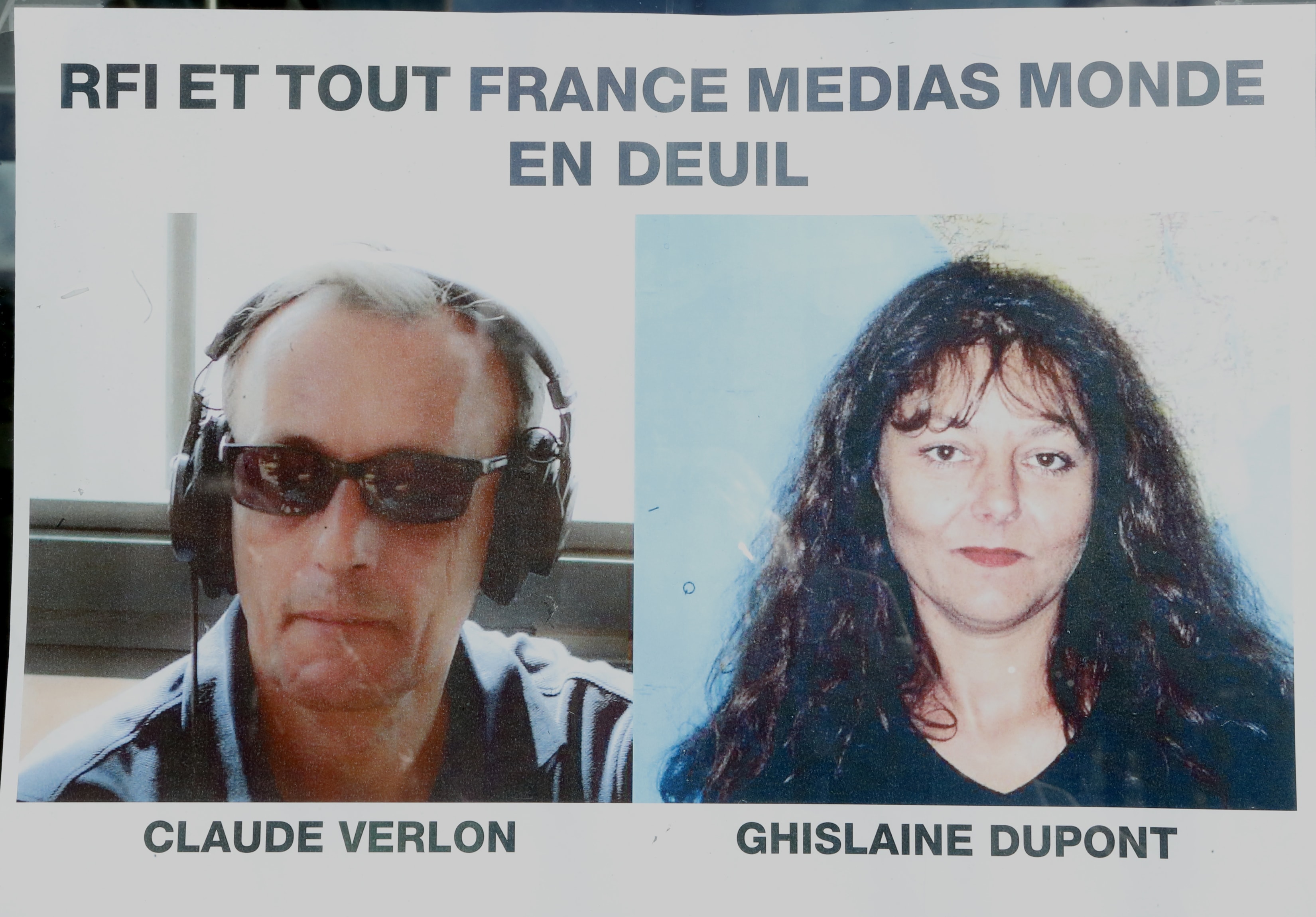 Pictures of Ghislaine Dupont, right, and Claude Verlon are displayed on a poster in Paris, 3 November 2013., AP Photo/Jacques Brinon