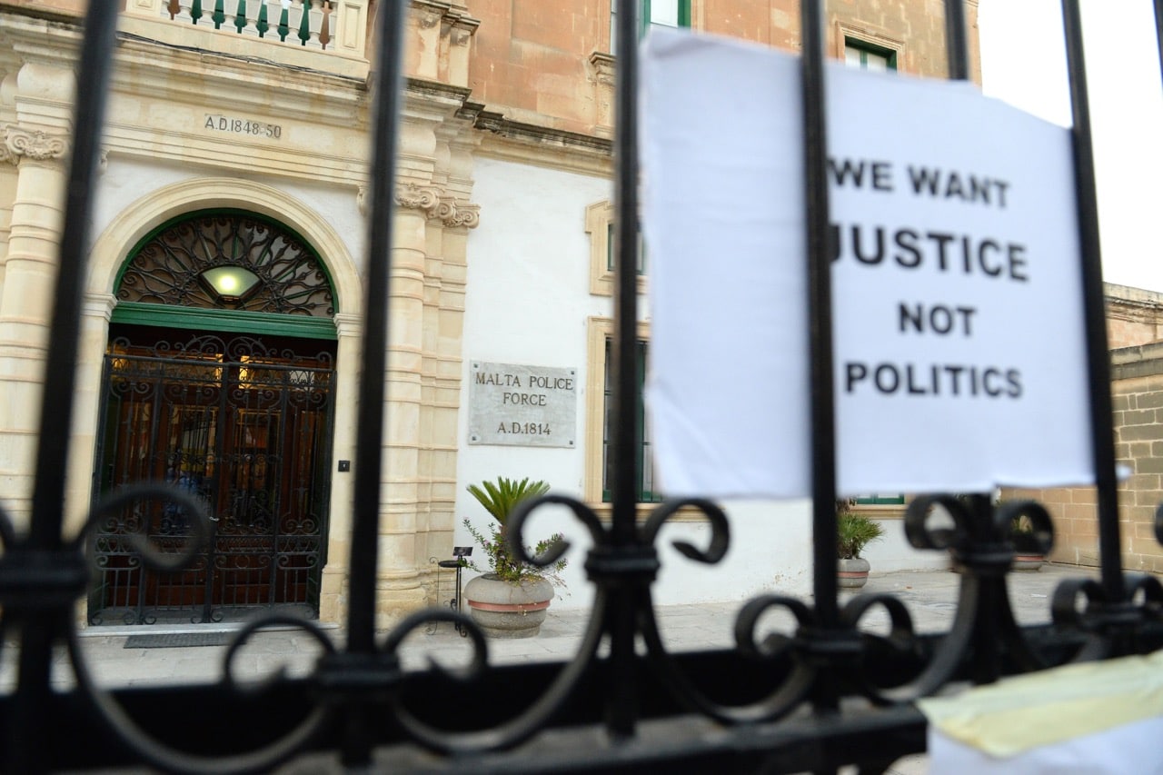 Signs are placed at the gates of the Police Headquarters during a national rally demanding justice for murdered journalist Daphne Caruana Galizia, in Valletta, Malta, 22 October 2017, MATTHEW MIRABELLI/AFP/Getty Images