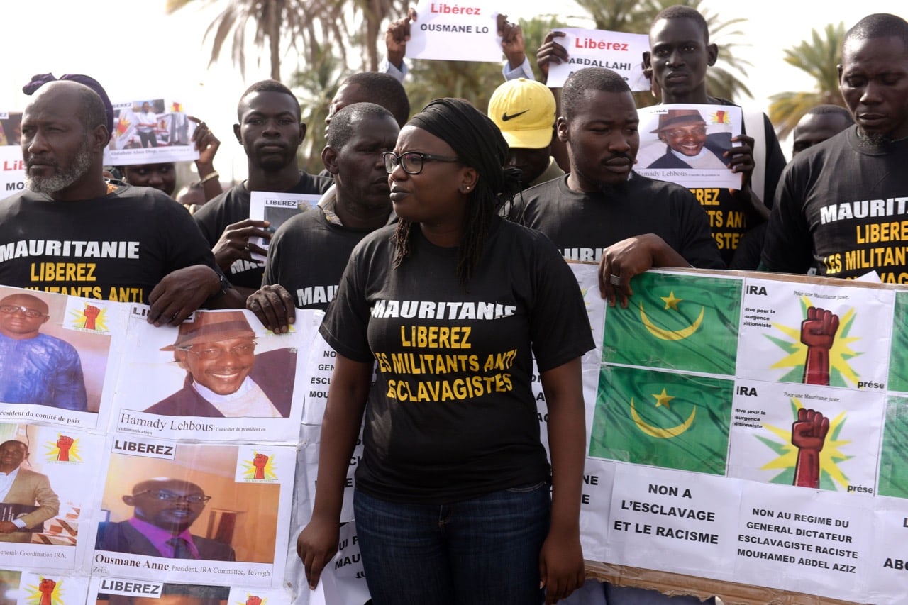 Anti-slavery activists hold a banner which reads 'Mauritania: No to slavery and racism', during a demonstration in Dakar, Senegal, 3 August 2016, SEYLLOU/AFP/Getty Images